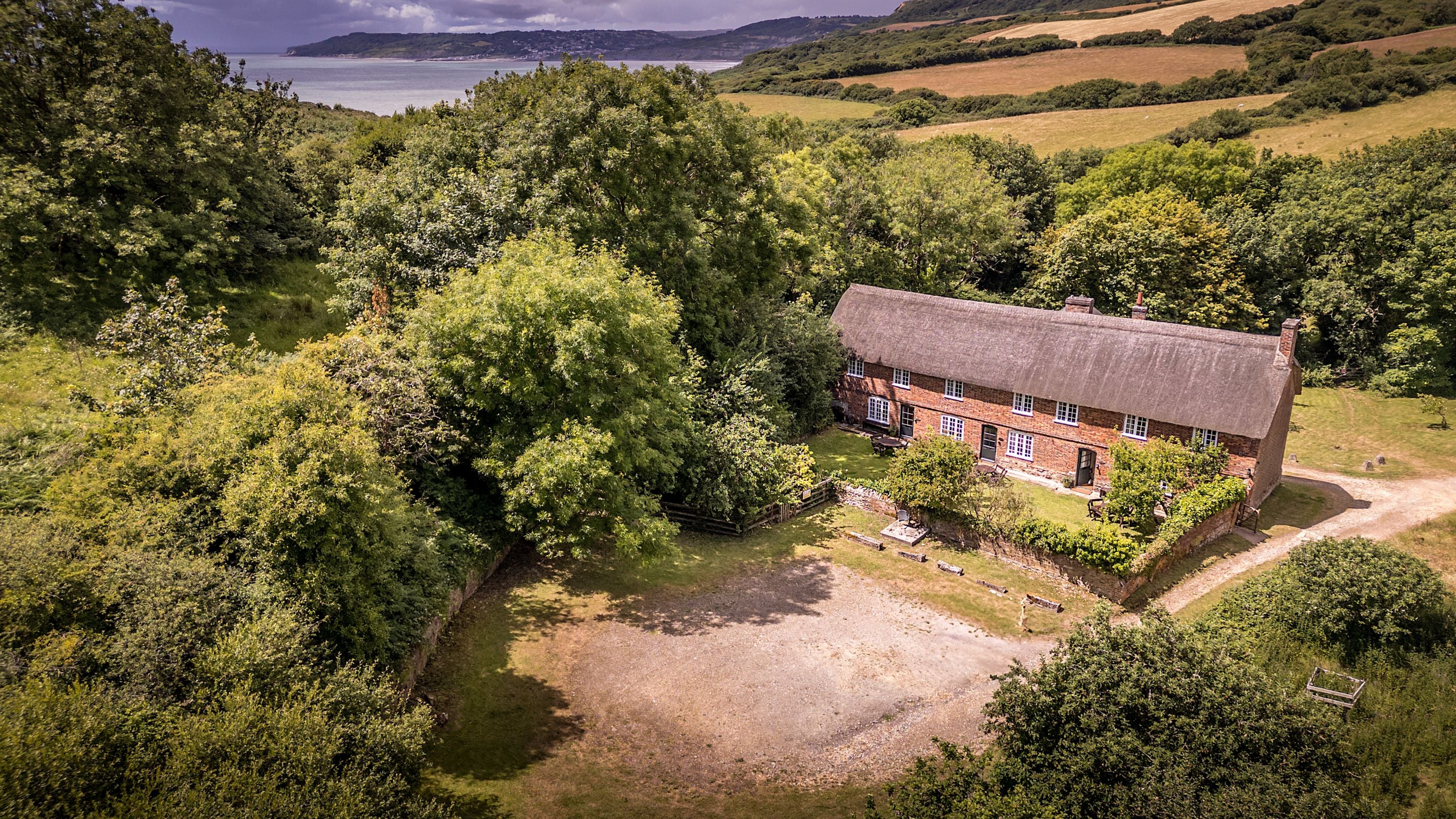 An aerial view of St Gabriel's Cottages, their shared garden and parking spaces, Dorset