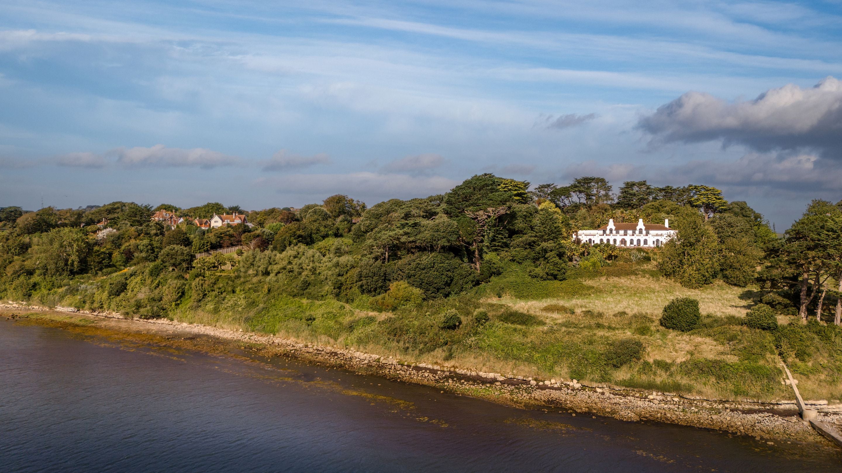 An aerial view of Portland House with the waters of Portland Harbour in the foreground, Dorset