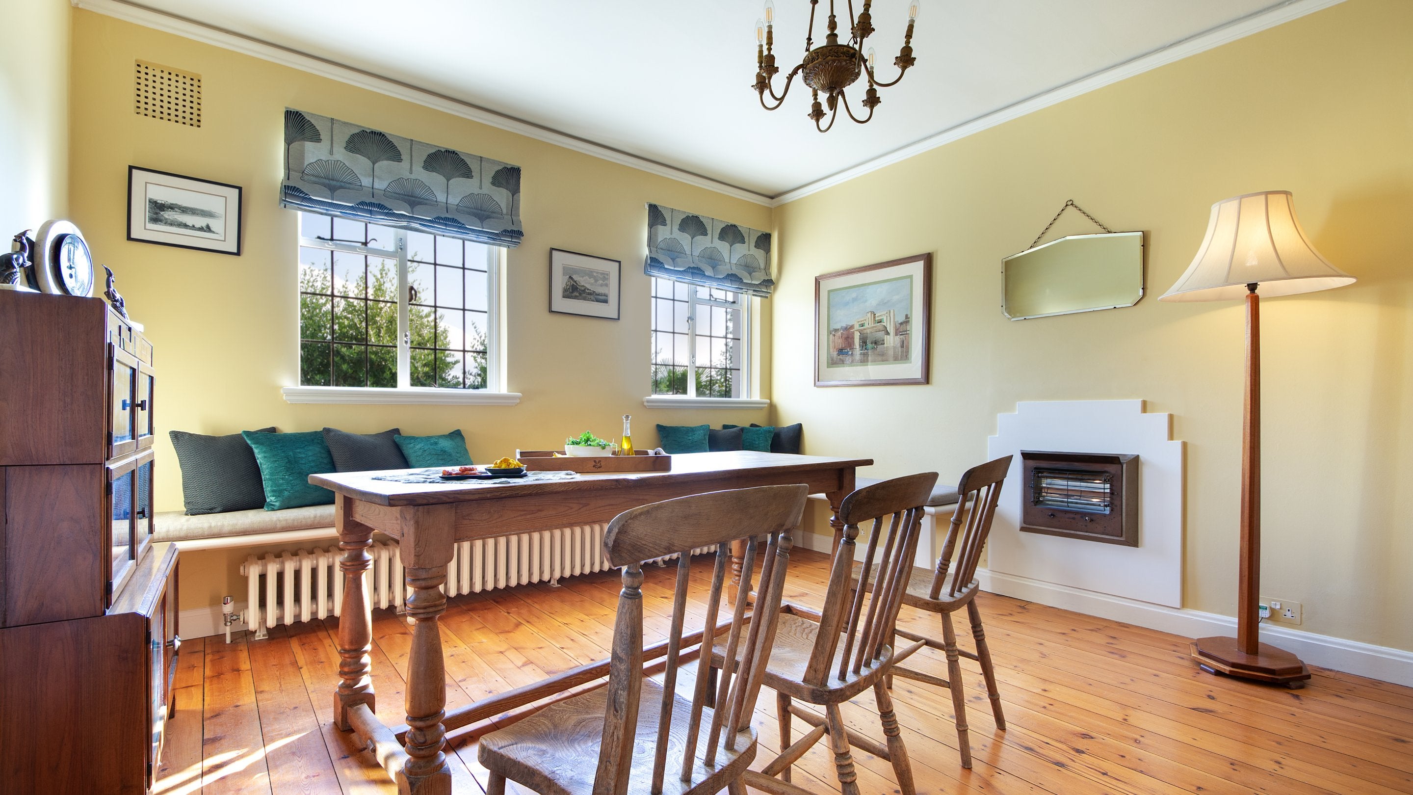 The breakfast room on the first floor of Portland House, with bench seating and chairs around the dining table, Dorset