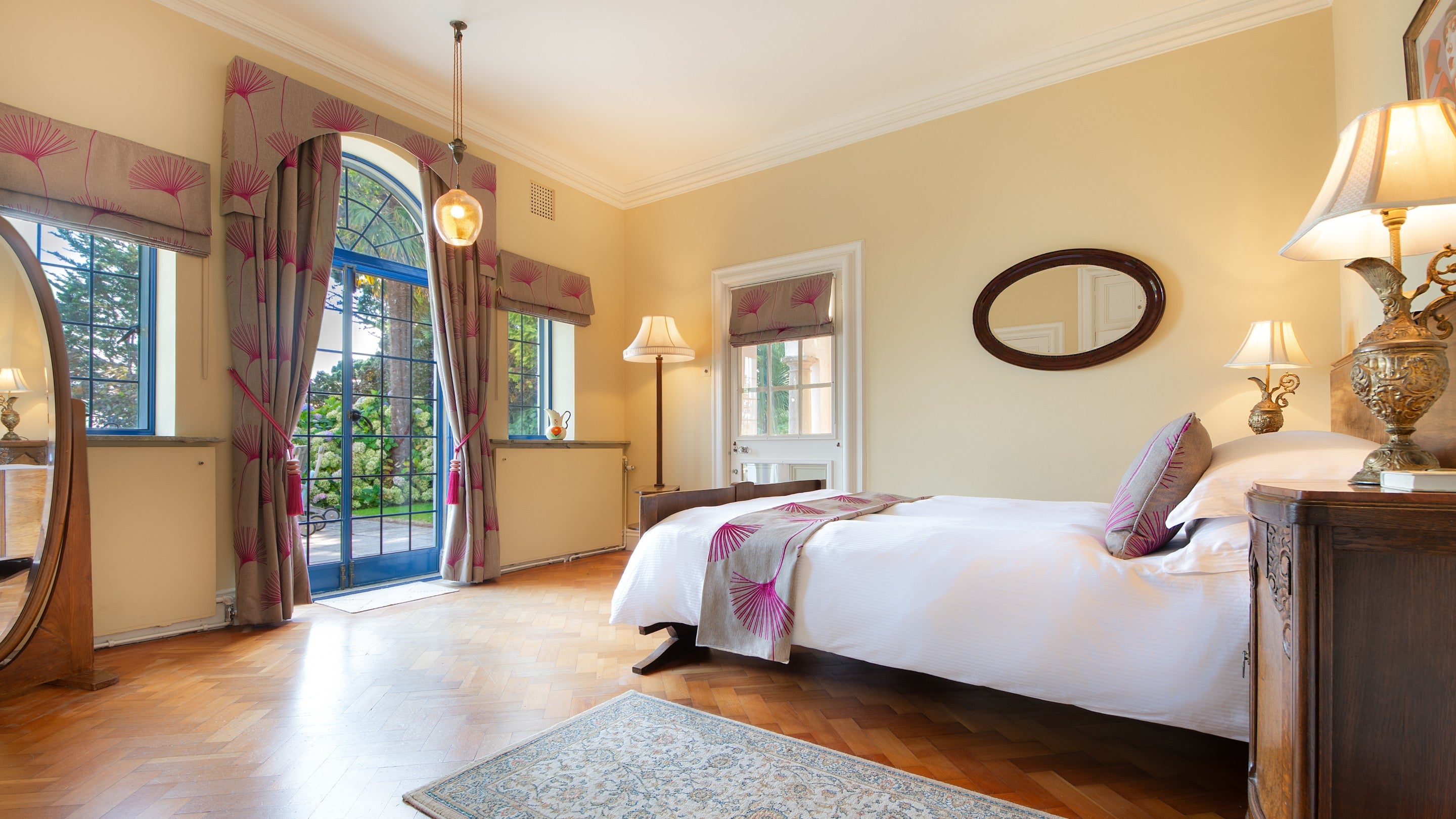 One of the double bedrooms on the ground floor, with a connecting door to the next double bedroom and external door to the lower terrace and covered loggia at the side of the house, Dorset