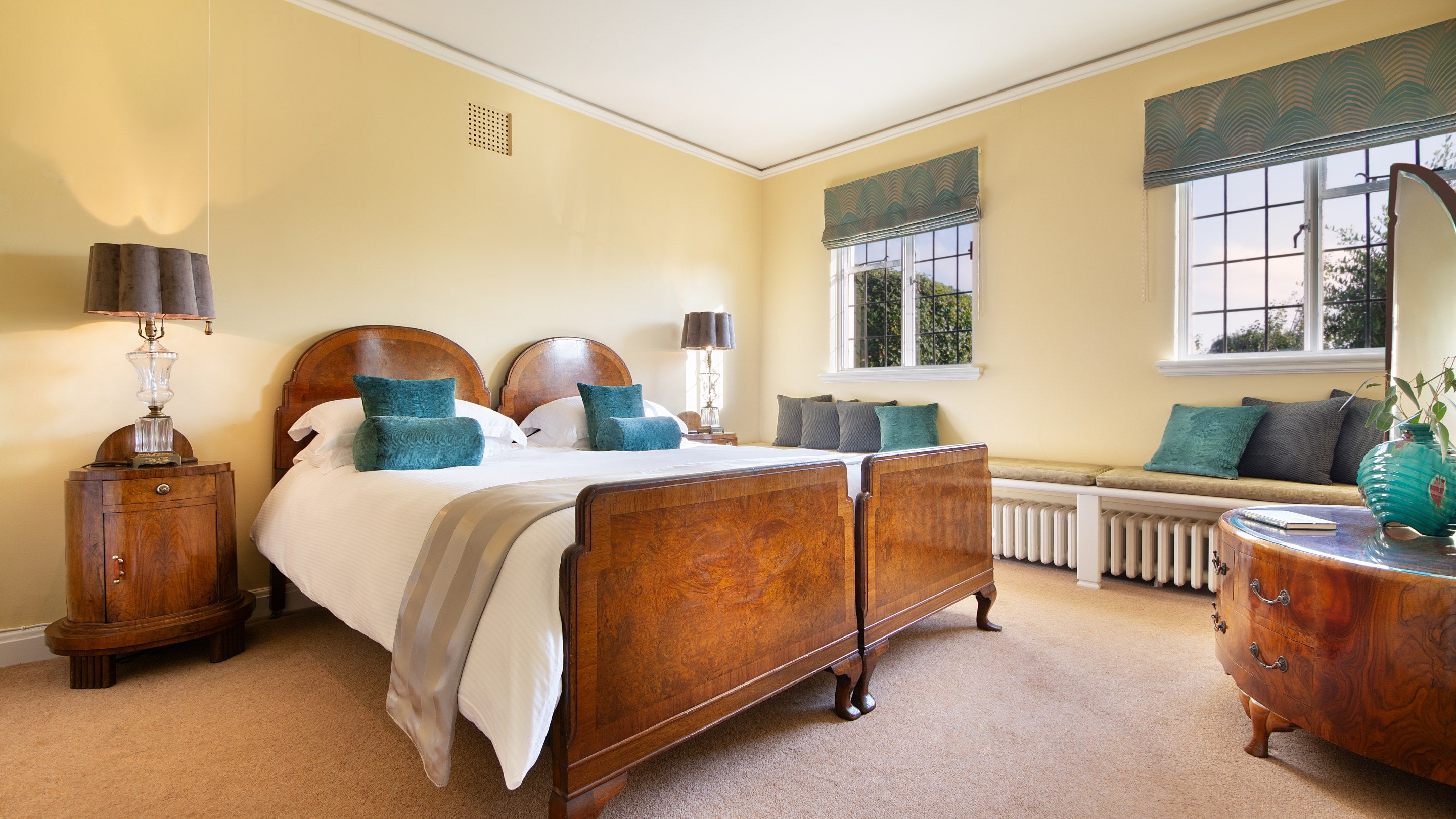 One of the double bedrooms on the first floor of Portland House, with bench seating below the windows, Dorset