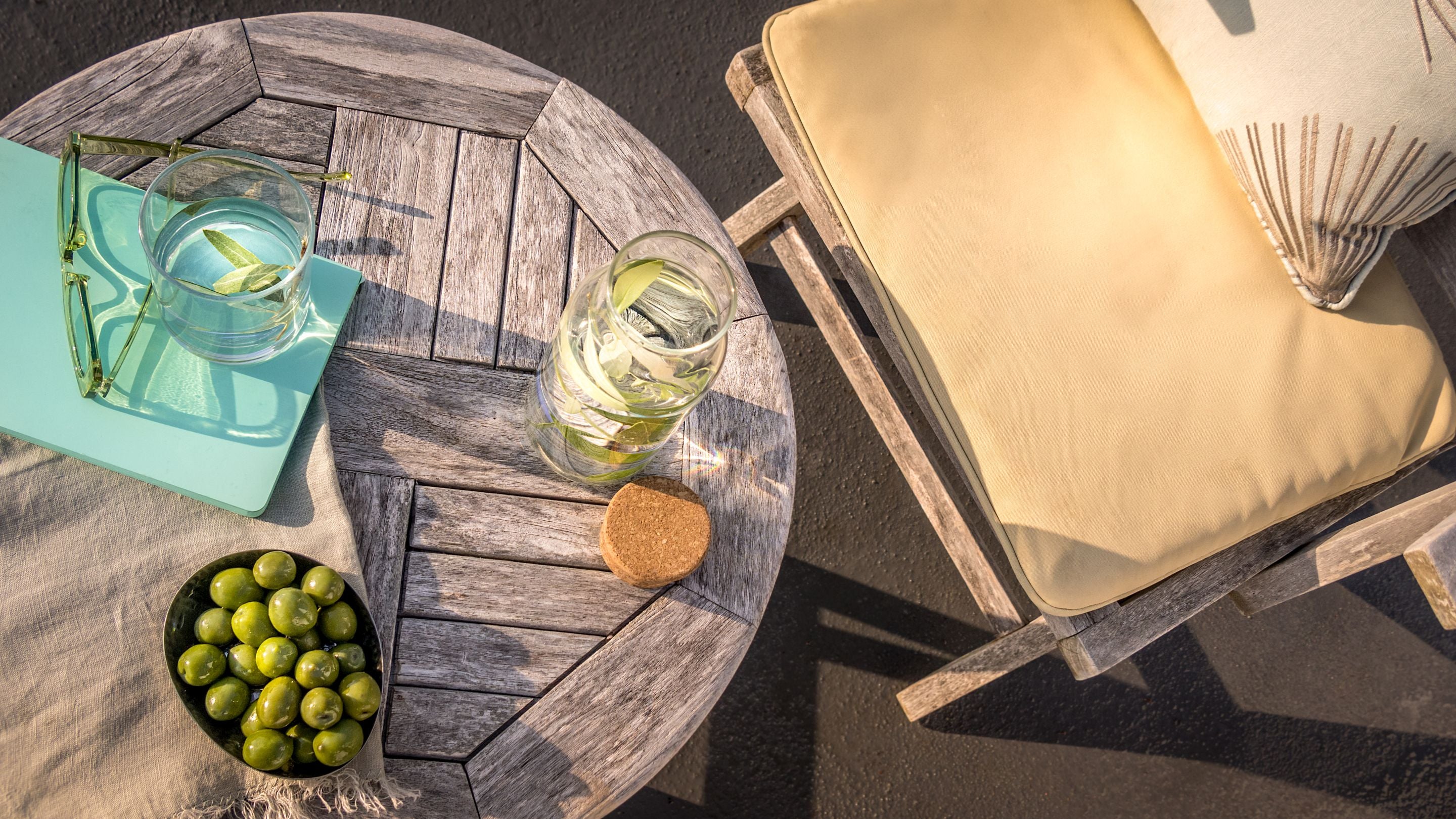 An outdoor table and chair on the upper terrace at Portland House, Dorset
