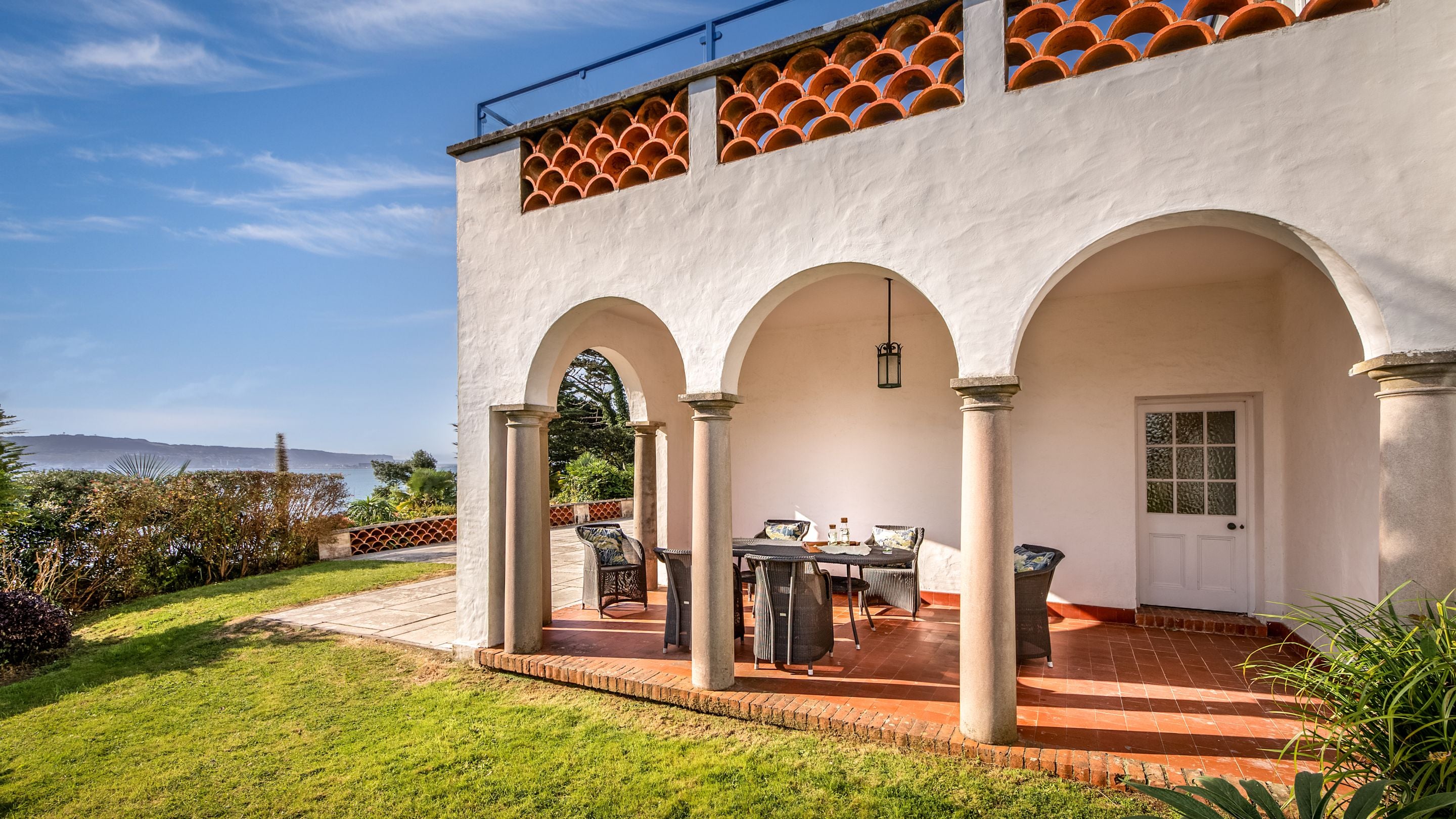 The covered loggia on the lower terrace, at the side of Portland House, Dorset