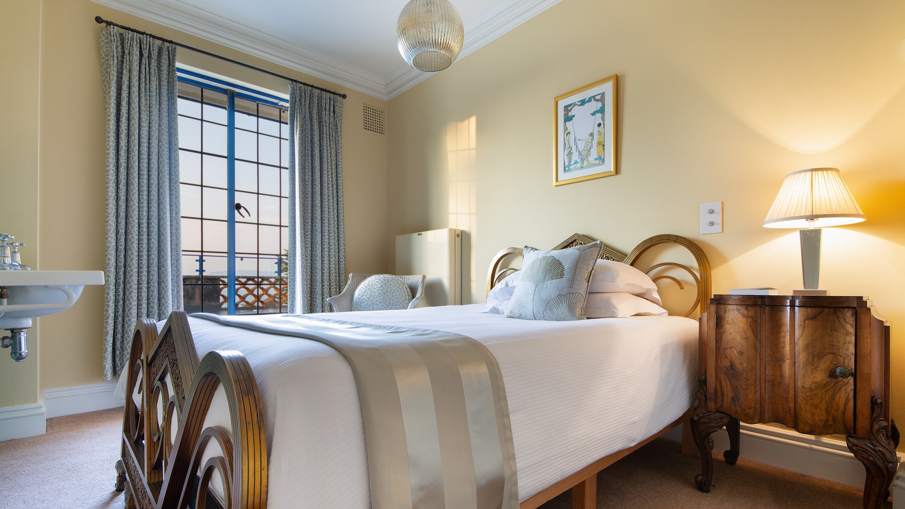 The single bedroom on the first floor of Portland House, with patio door to the upper terrace, Dorset