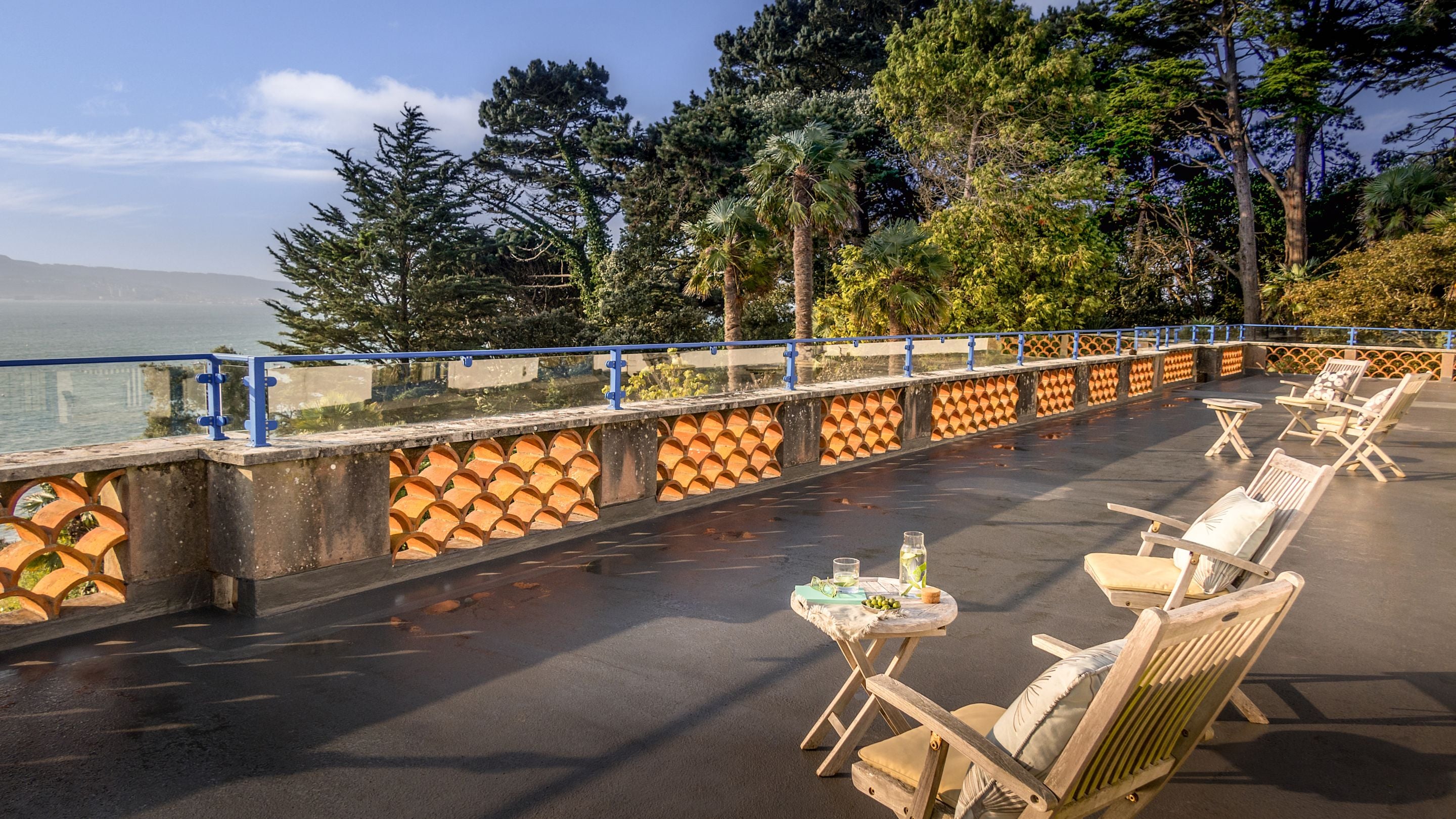 The upper terrace at Portland House, with outdoor furniture, overlooking the harbour, Dorset