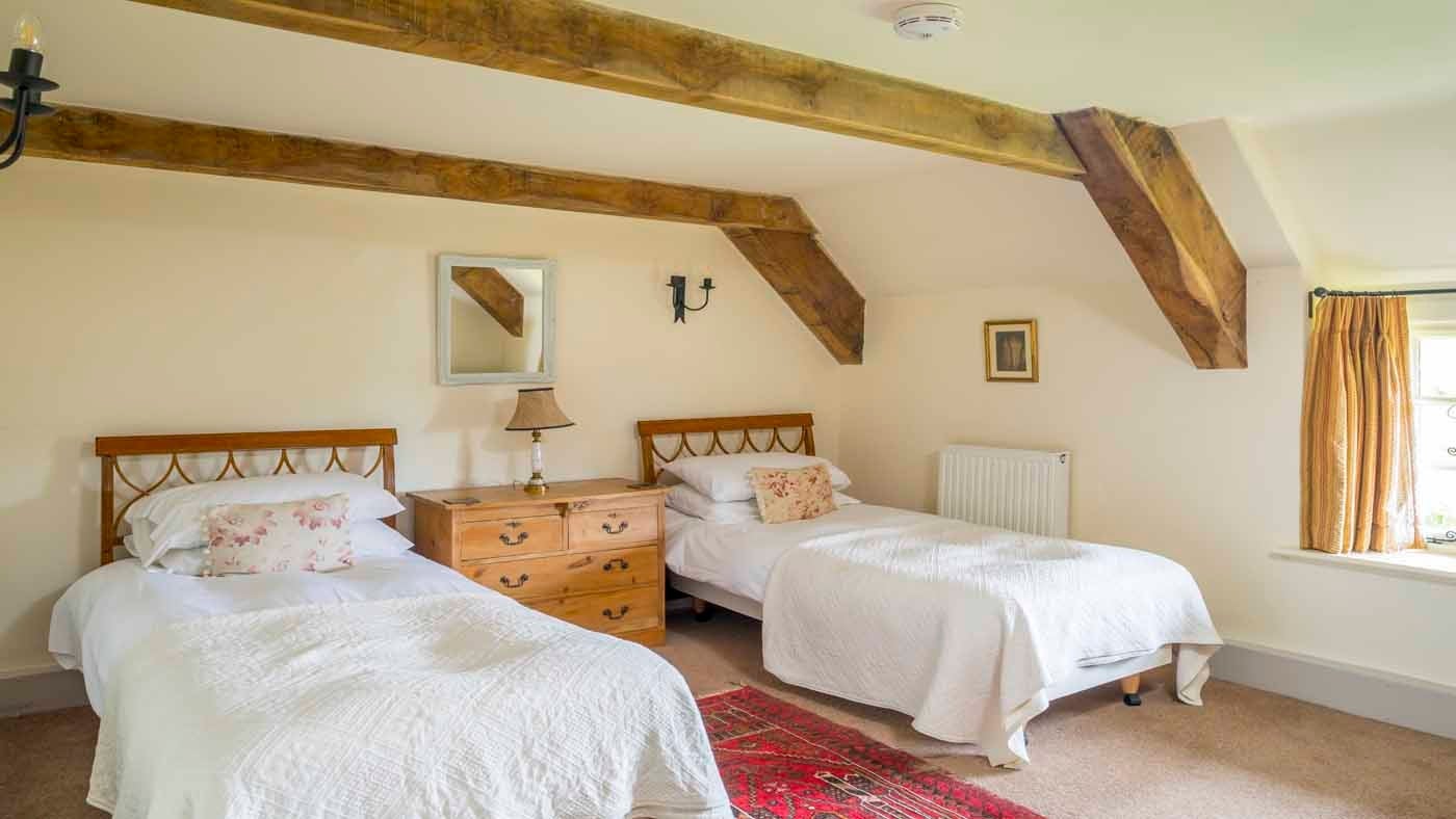 Interior twin bedroom of Shedbush Farmhouse, nr Bridport, Dorset