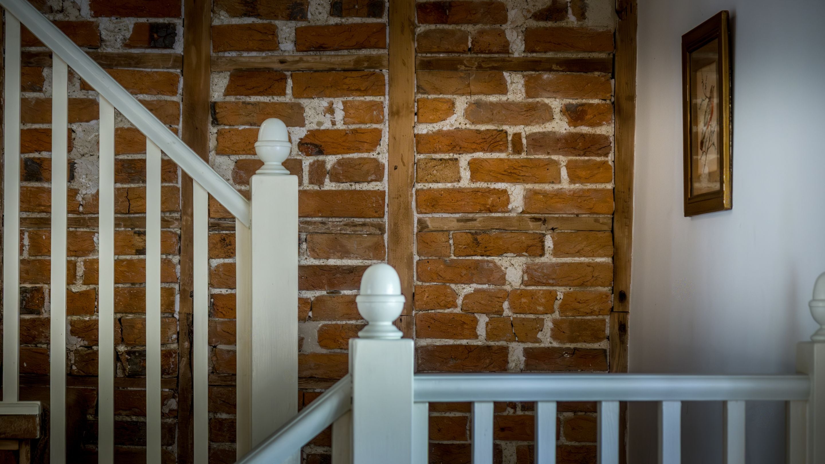 The exposed brick wall in the kitchen at Shedbush Farm House, Dorset