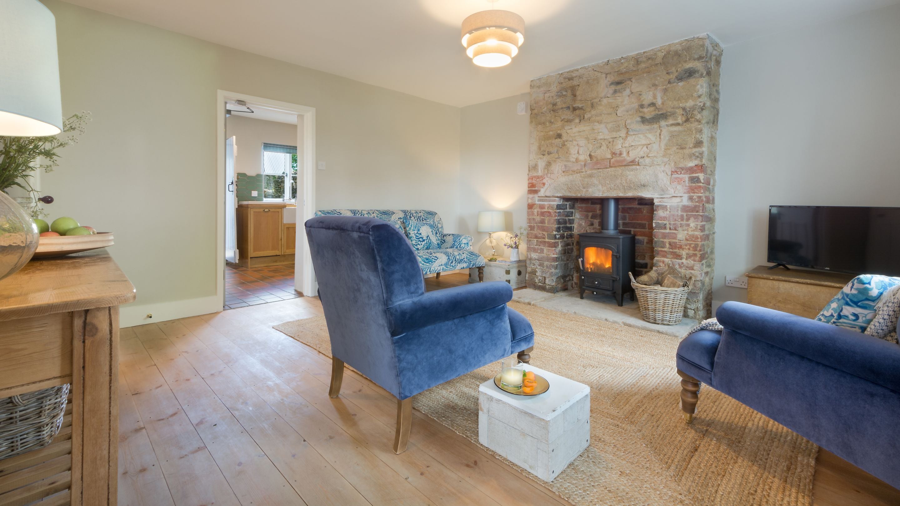 The sitting room with the door open to the kitchen at Spyway, Dorset