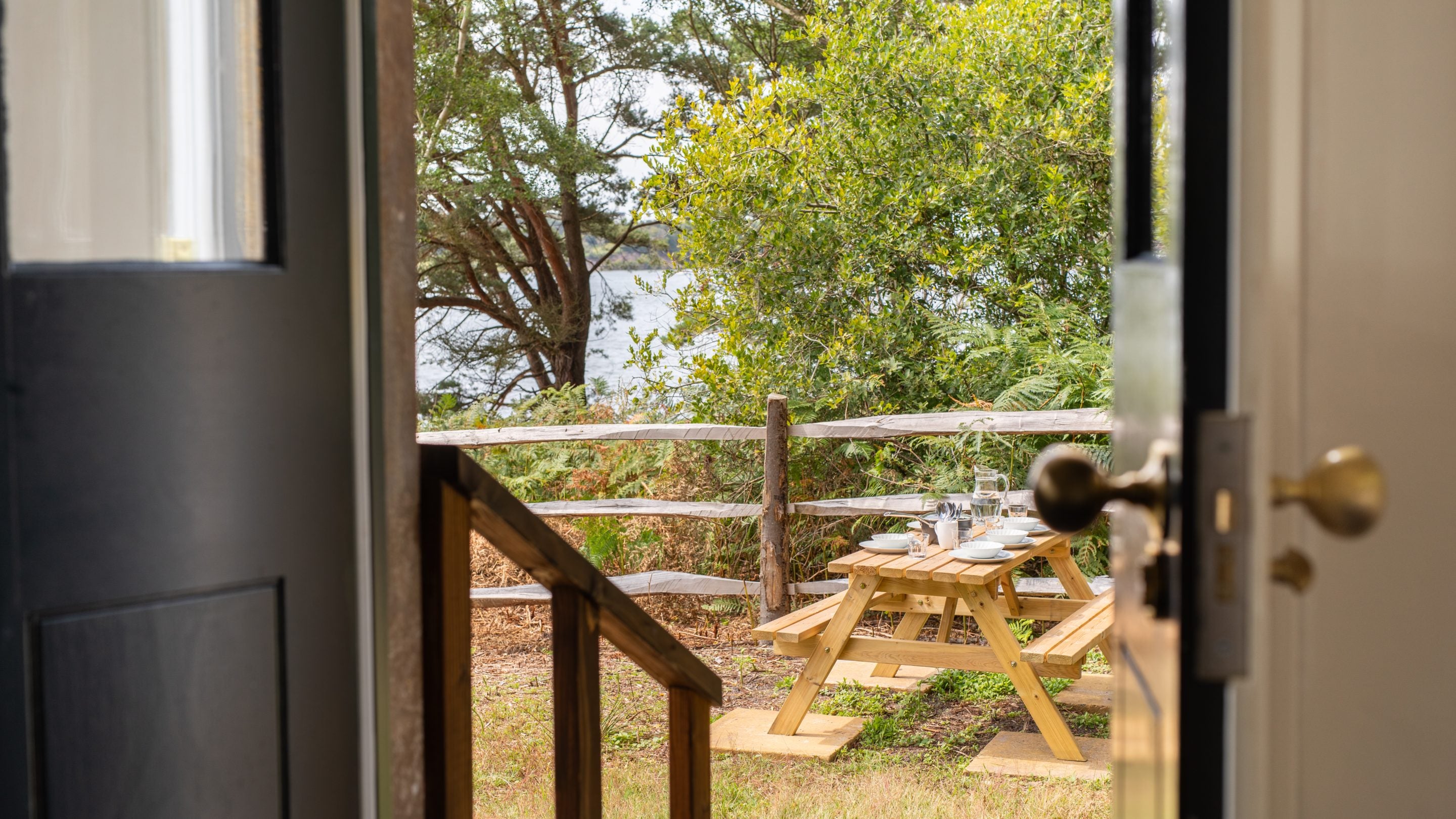 A view out to the picnic table in the enclosed space outside St Mark's Bothy, Brownsea Island, Dorset