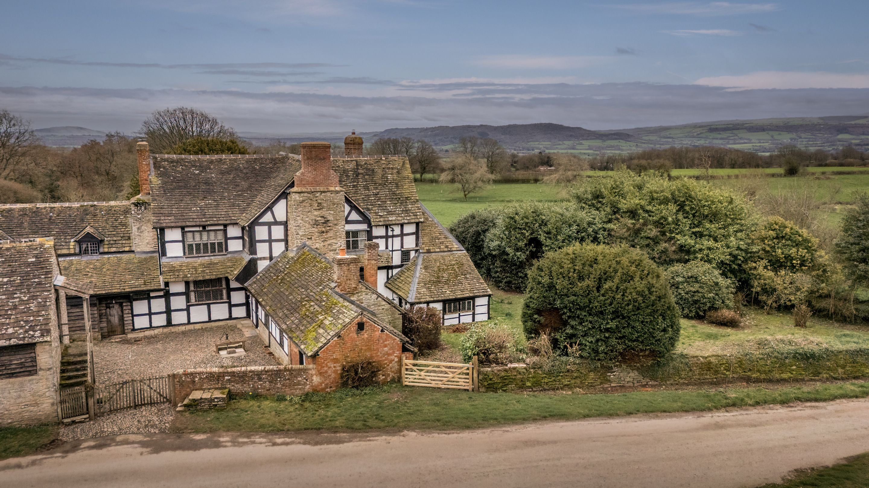 An aerial view of Cwmmau Farmhouse and the surrounding countryside, Herefordshire