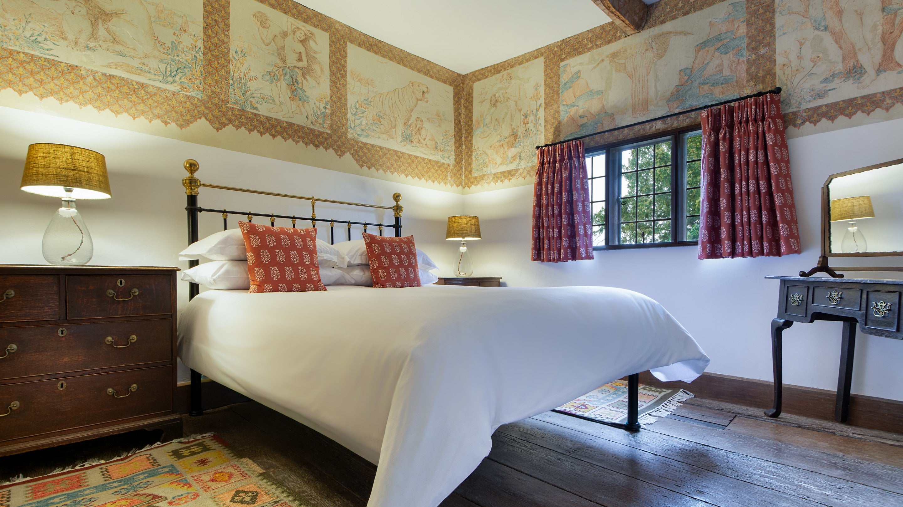 One of the double bedrooms at Cwmmau Farmhouse, with drawings of animals and people on the walls made by one of the previous owners, Herefordshire