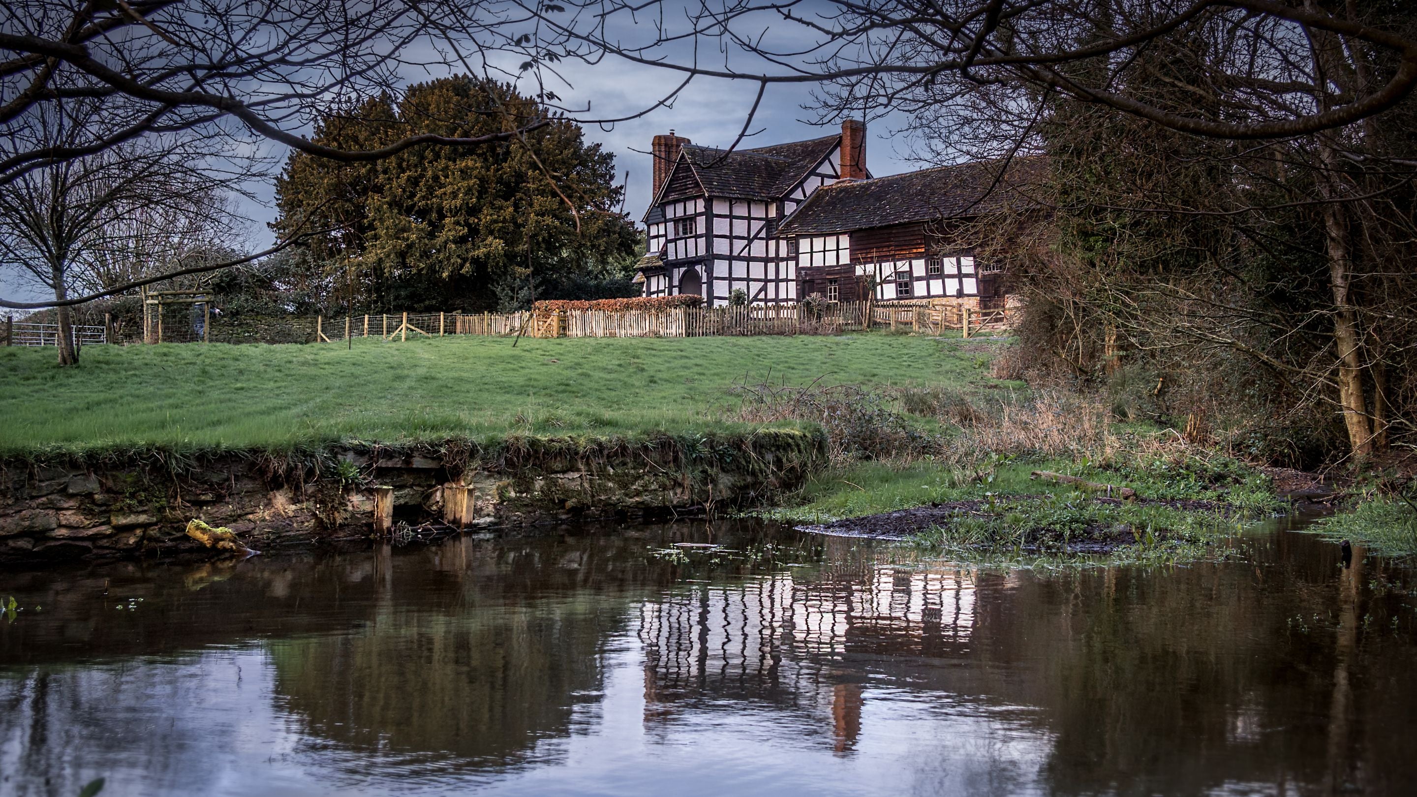 Cwmmau Farmhouse viewed from a nearby pond, Herefordshire