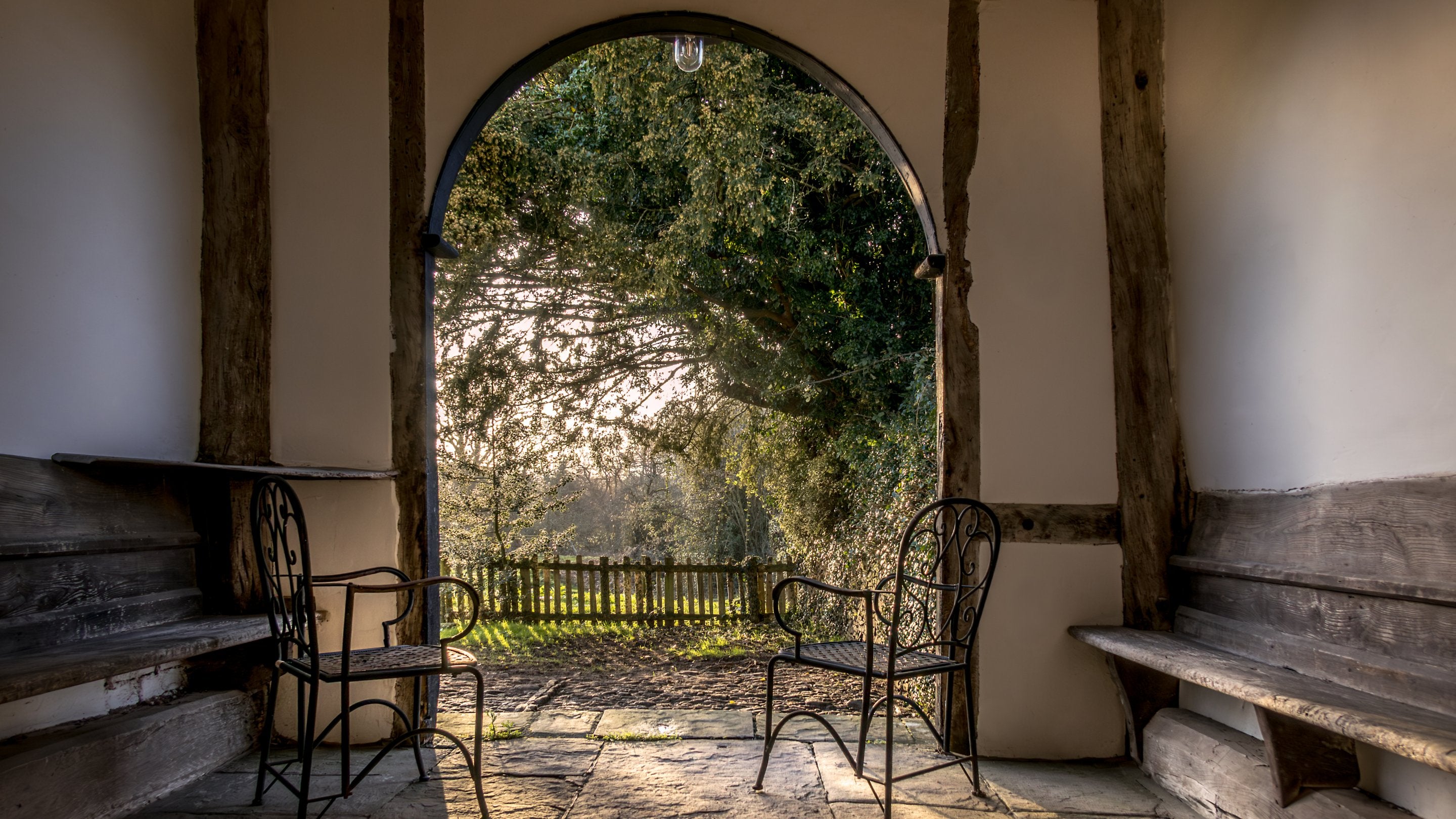 The open porch with benches at Cwmmau Farmhouse, Herefordshire