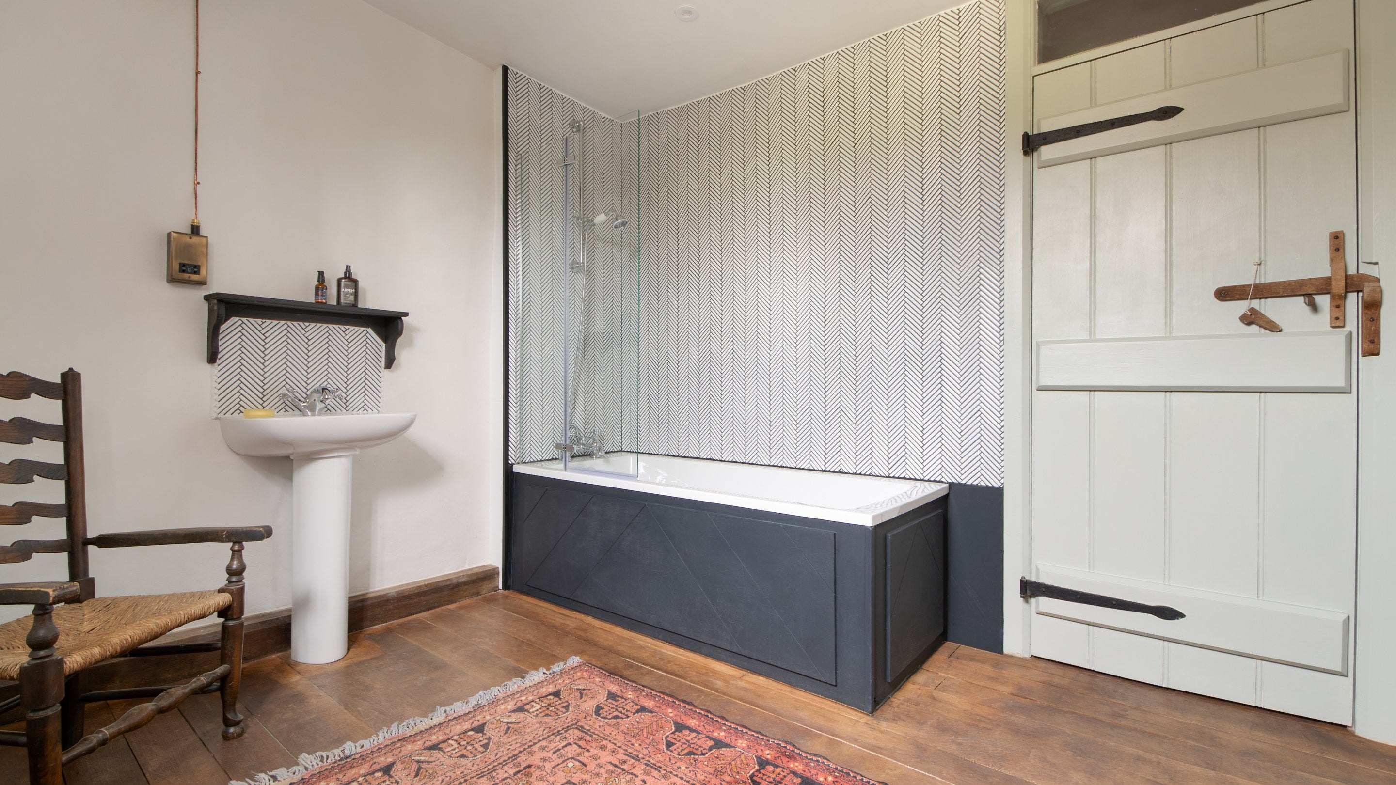 One of the bathrooms at Cwmmau Farmhouse, with shower over bath, Herefordshire