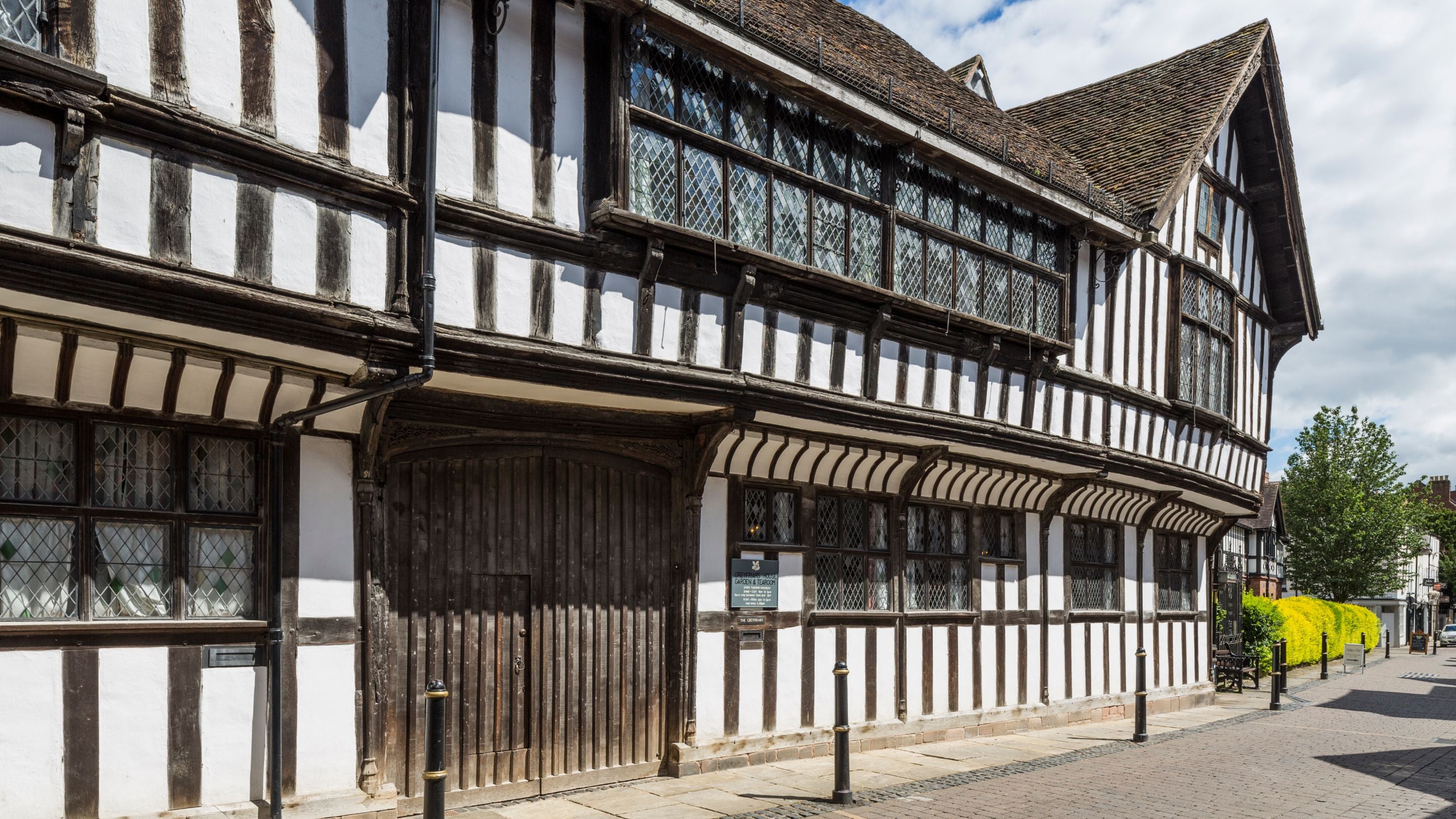 Greyfriars House viewed from the street with the large wooden doors of the main entrance on the left, Worcestershire