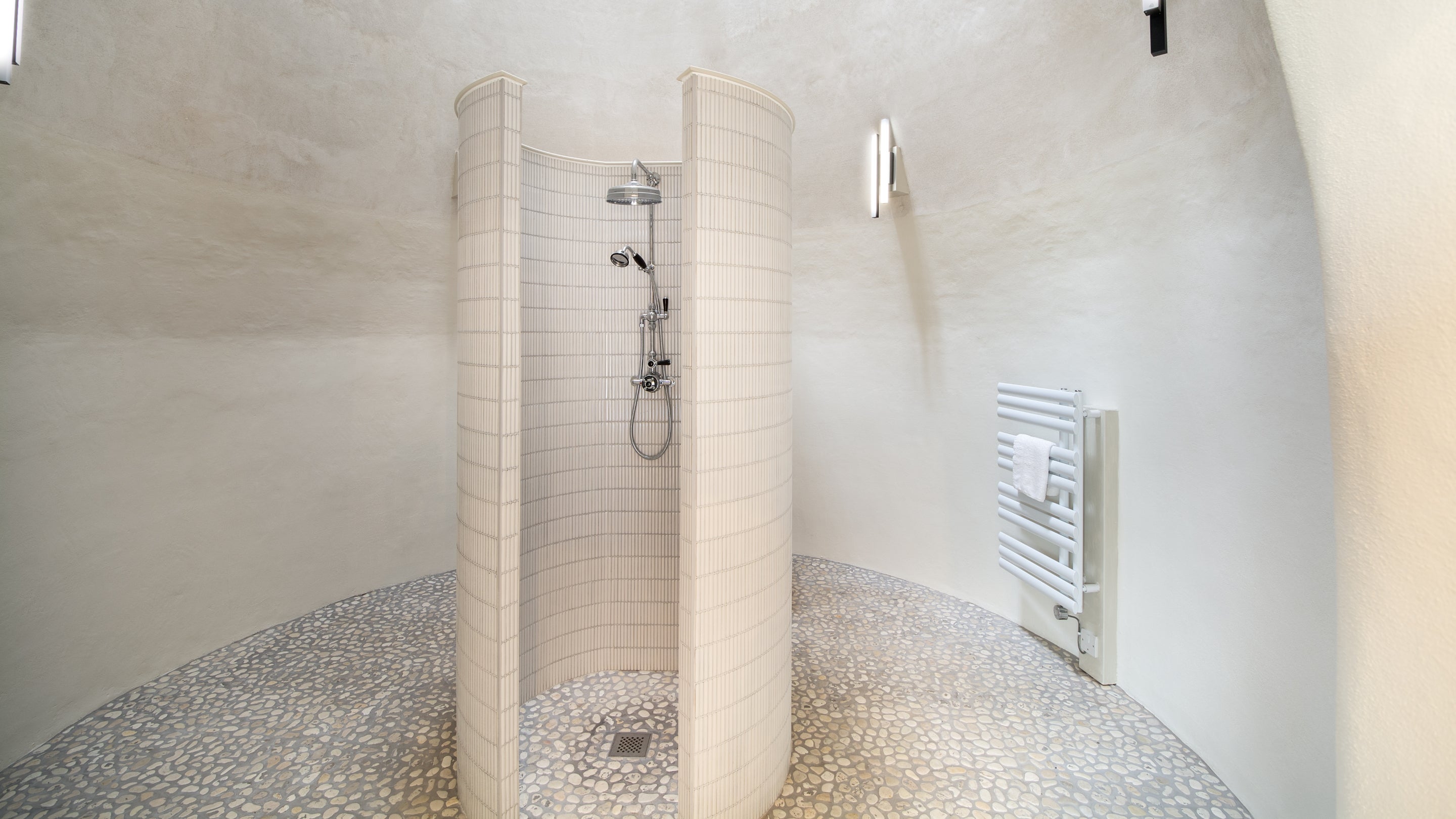 The shower looks up into the tall, conical roof of the kiln in the shower room at Hop Kiln Mews, Herefordshire