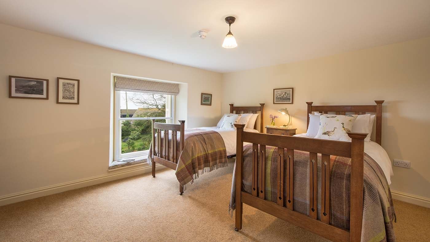A twin bedroom at Mottistone Manor Farmhouse, Mottistone, Isle of Wight