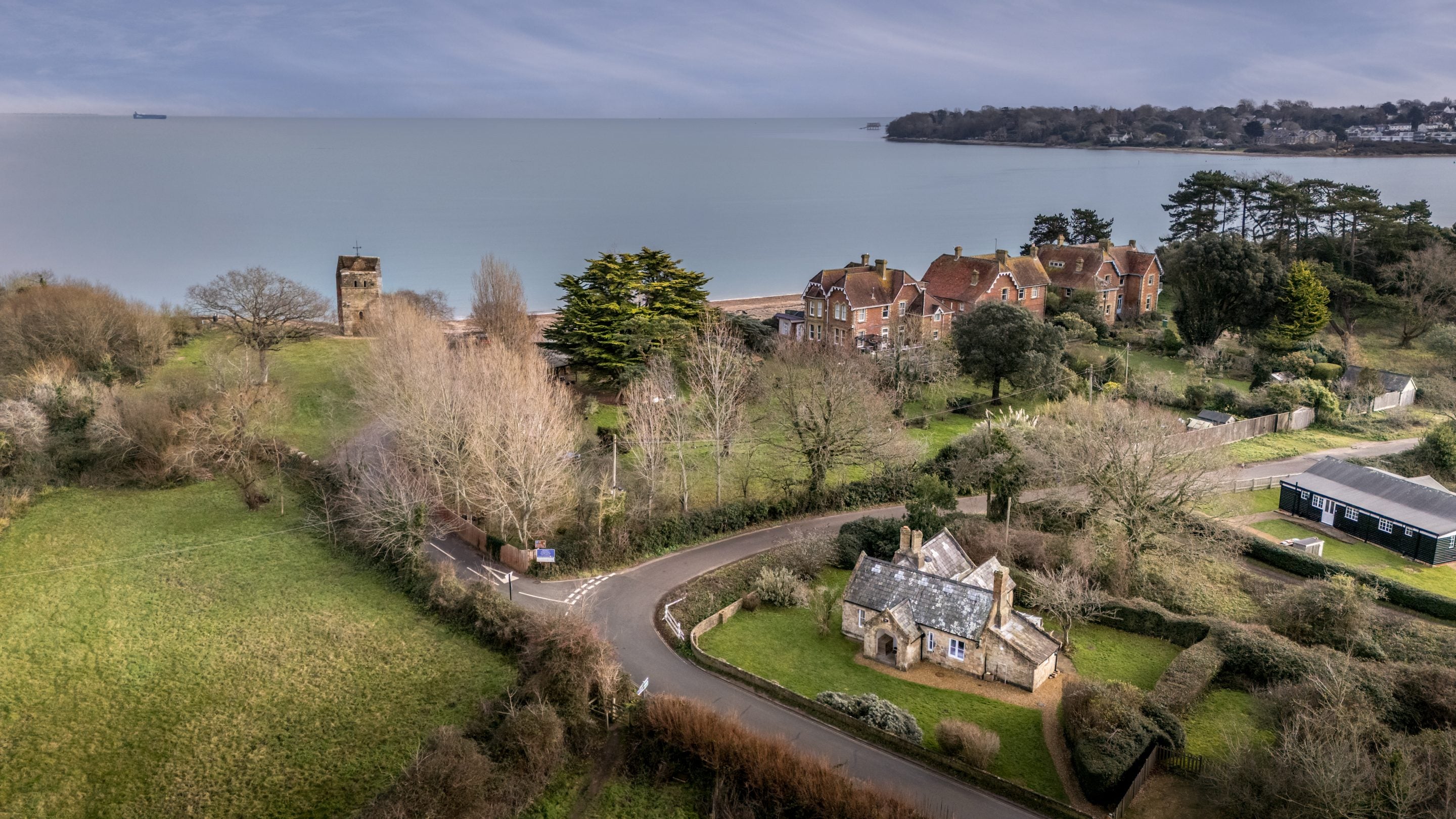 An aerial view of Old Church Lodge with the sea and sands of Duver Beach in the background, a few minute's walk from the cottage, Isle Of Wight