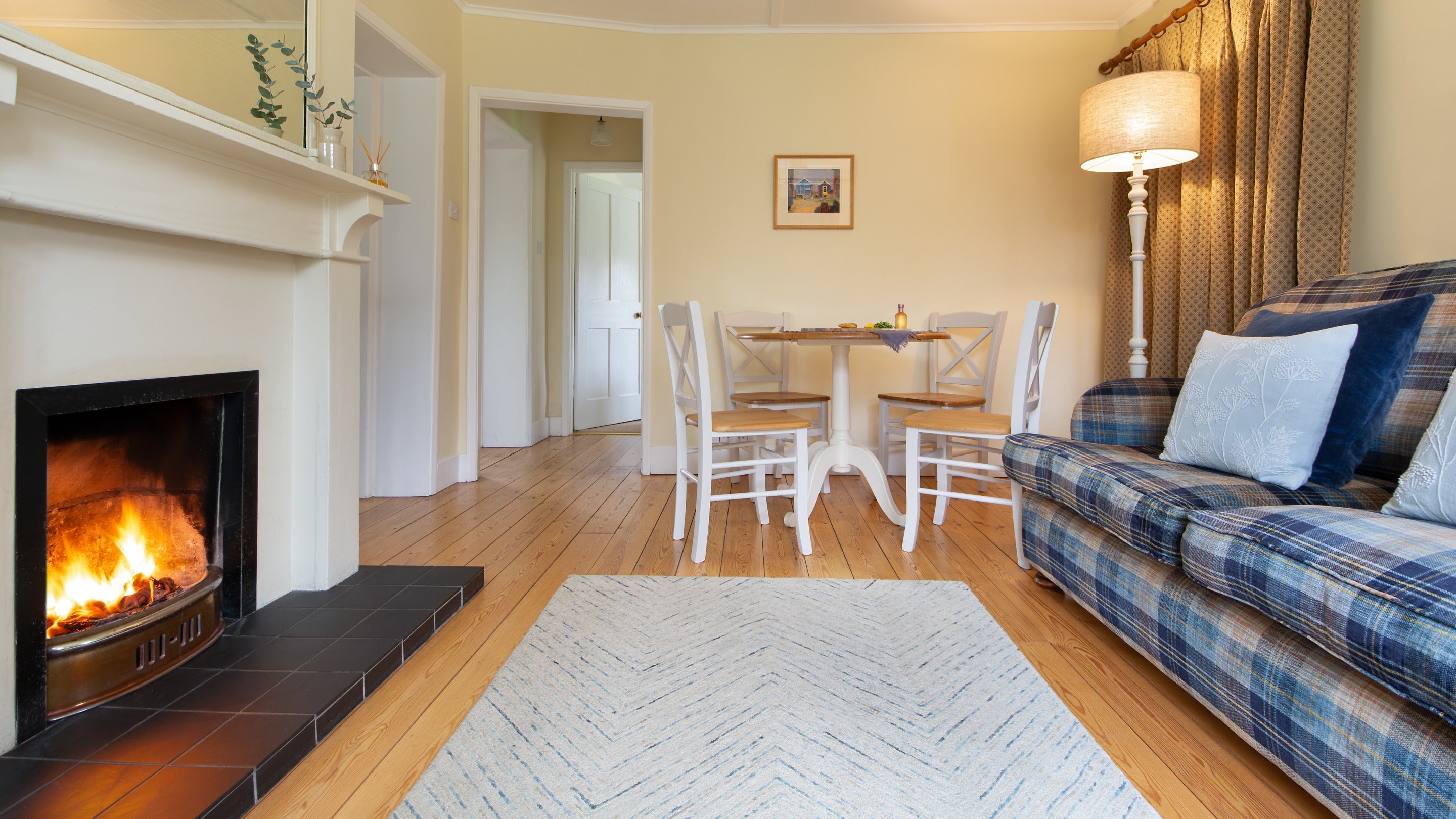 The sitting room with dining table for four at Old Church Lodge, Isle Of Wight
