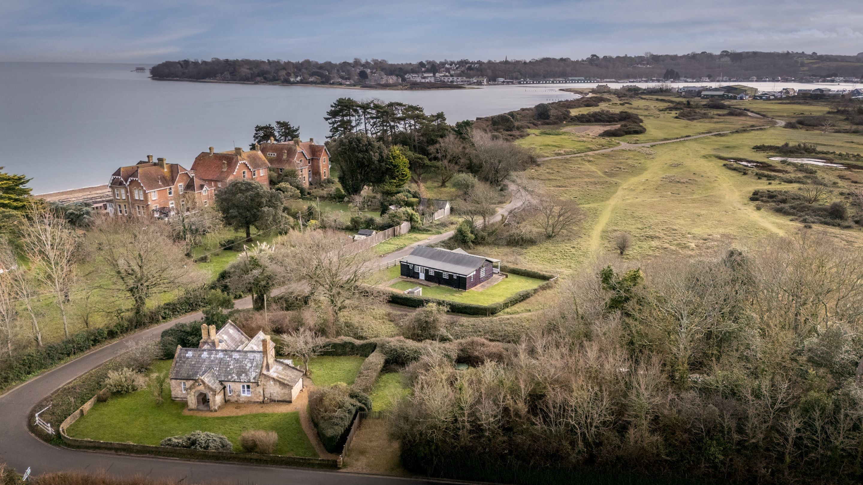 An aerial view of The Old Club House, with the sea, the sands of Duver Beach and the old golf course in the background, Isle Of Wight