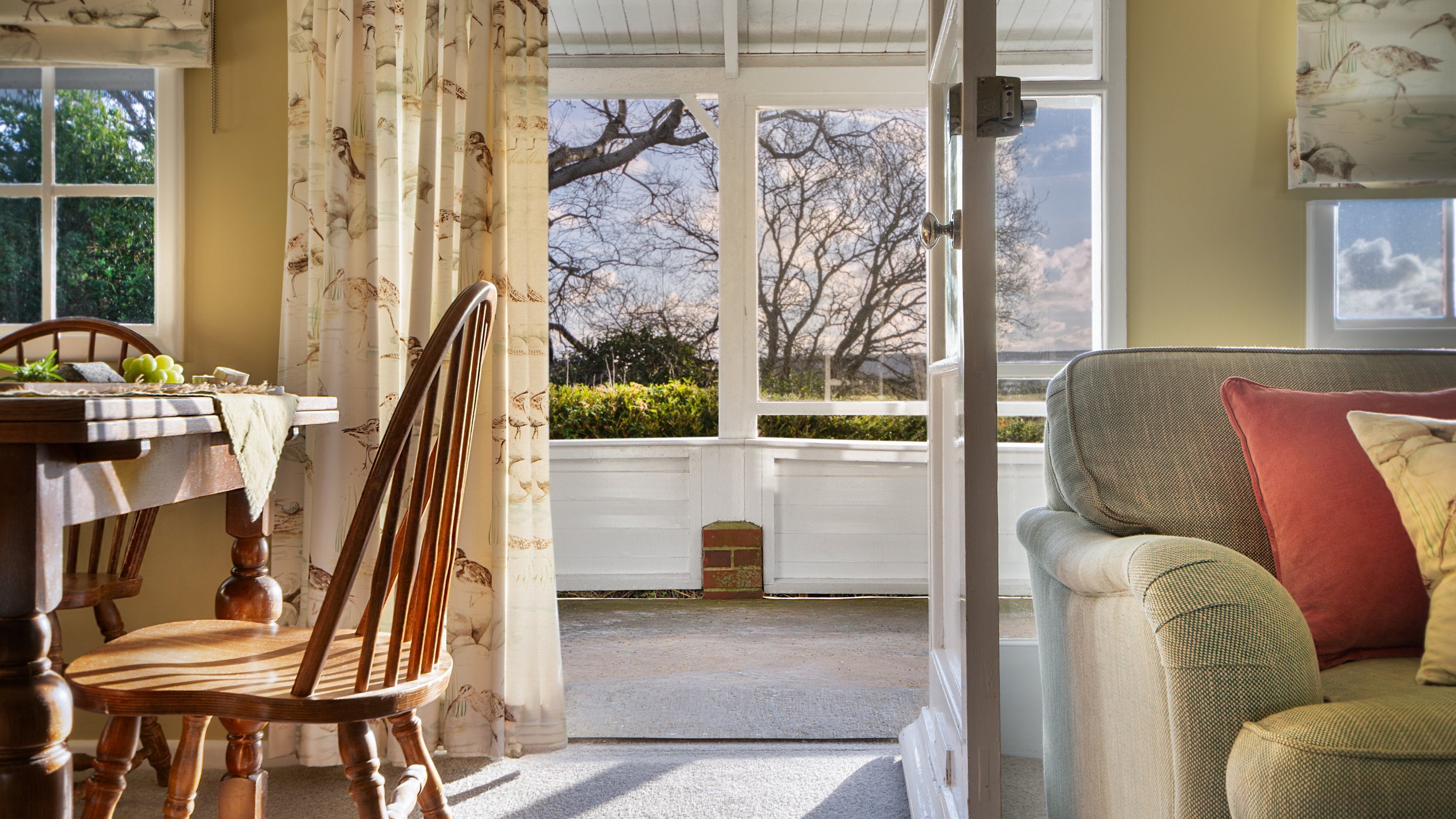 The door to the veranda from the open-plan sitting and dining room at The Old Clubhouse, Isle Of Wight