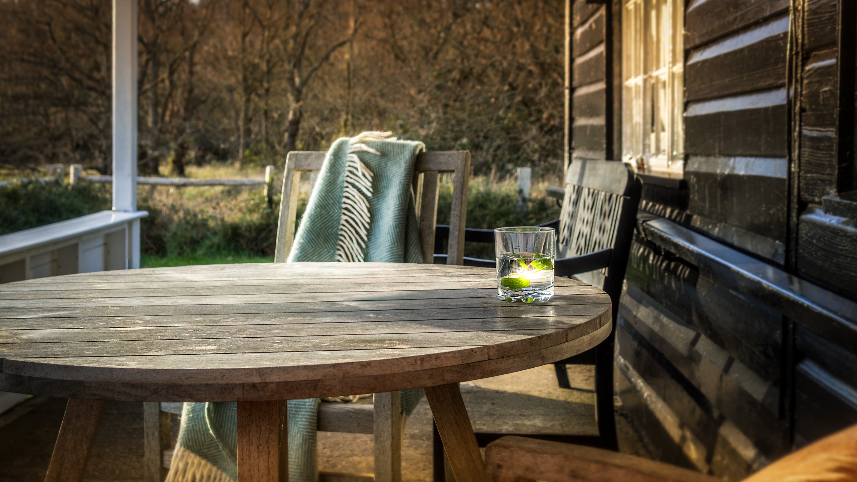An outdoor table and chairs on the veranda at The Old Club House, Isle Of Wight