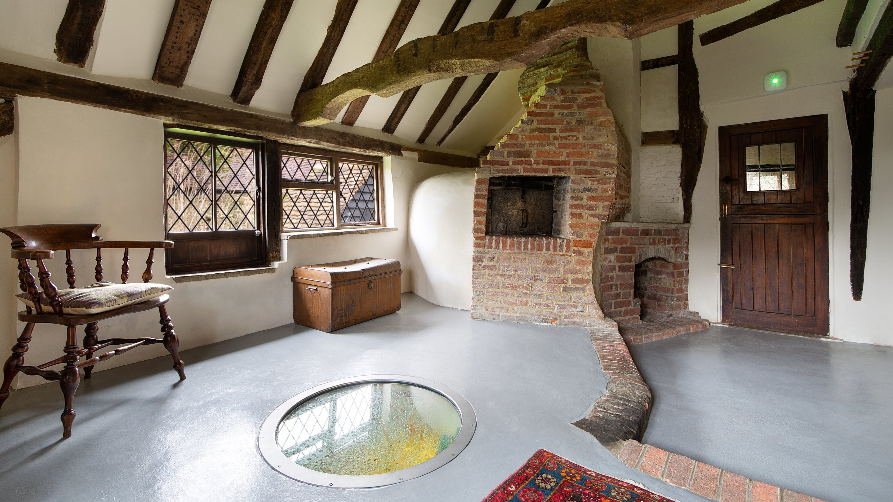 The bake room with original well at Emley Farmhouse, Surrey