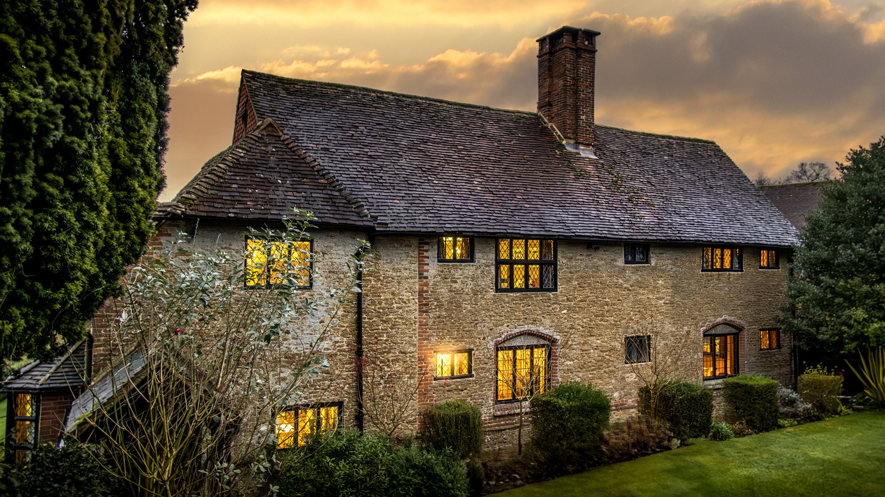 The exterior of Emley Farmhouse at dusk, Surrey