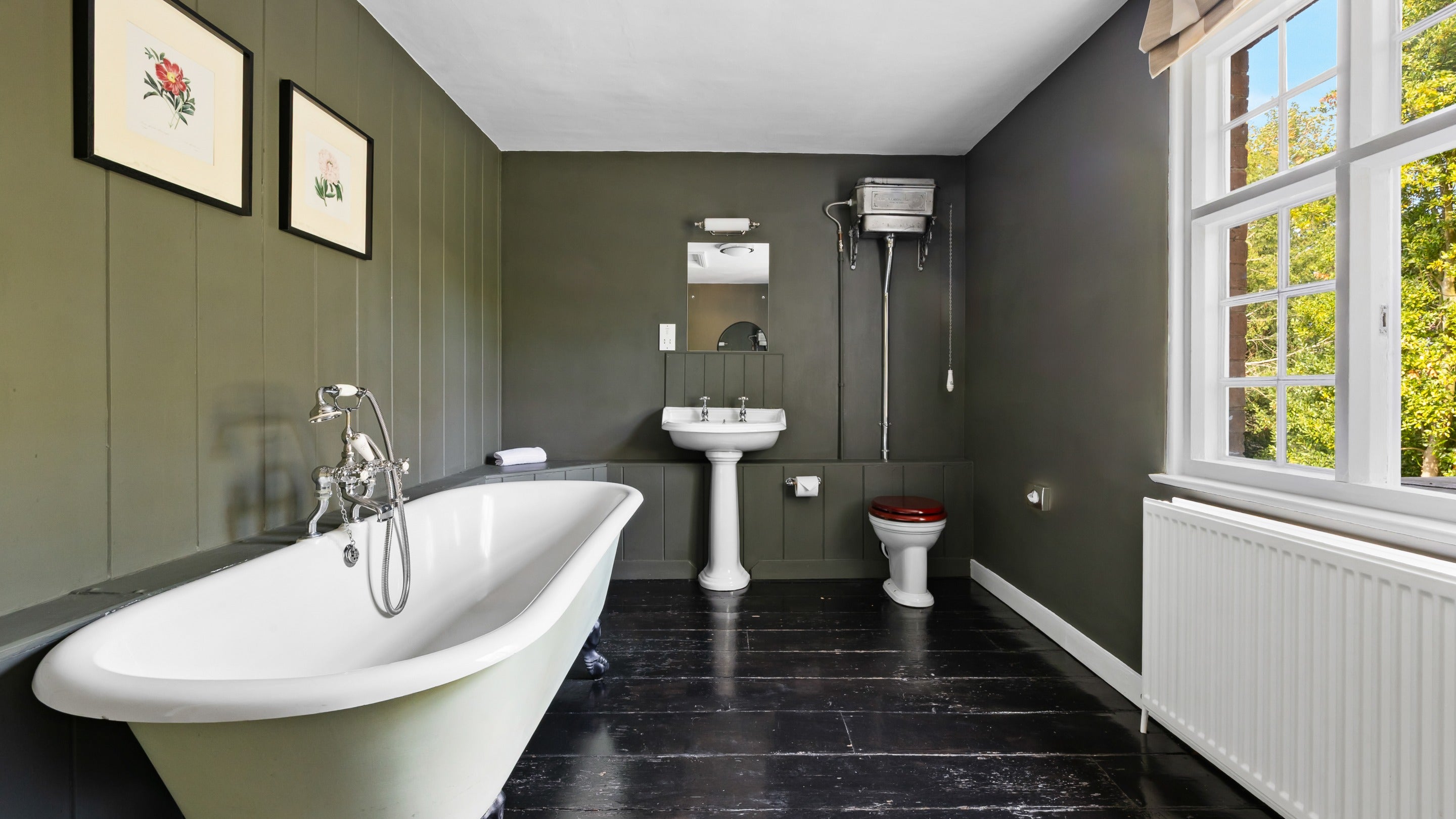 The bathroom on the first floor of Polesden Garden Cottage with roll-top bath with shower attachment (no wall hook) , Surrey