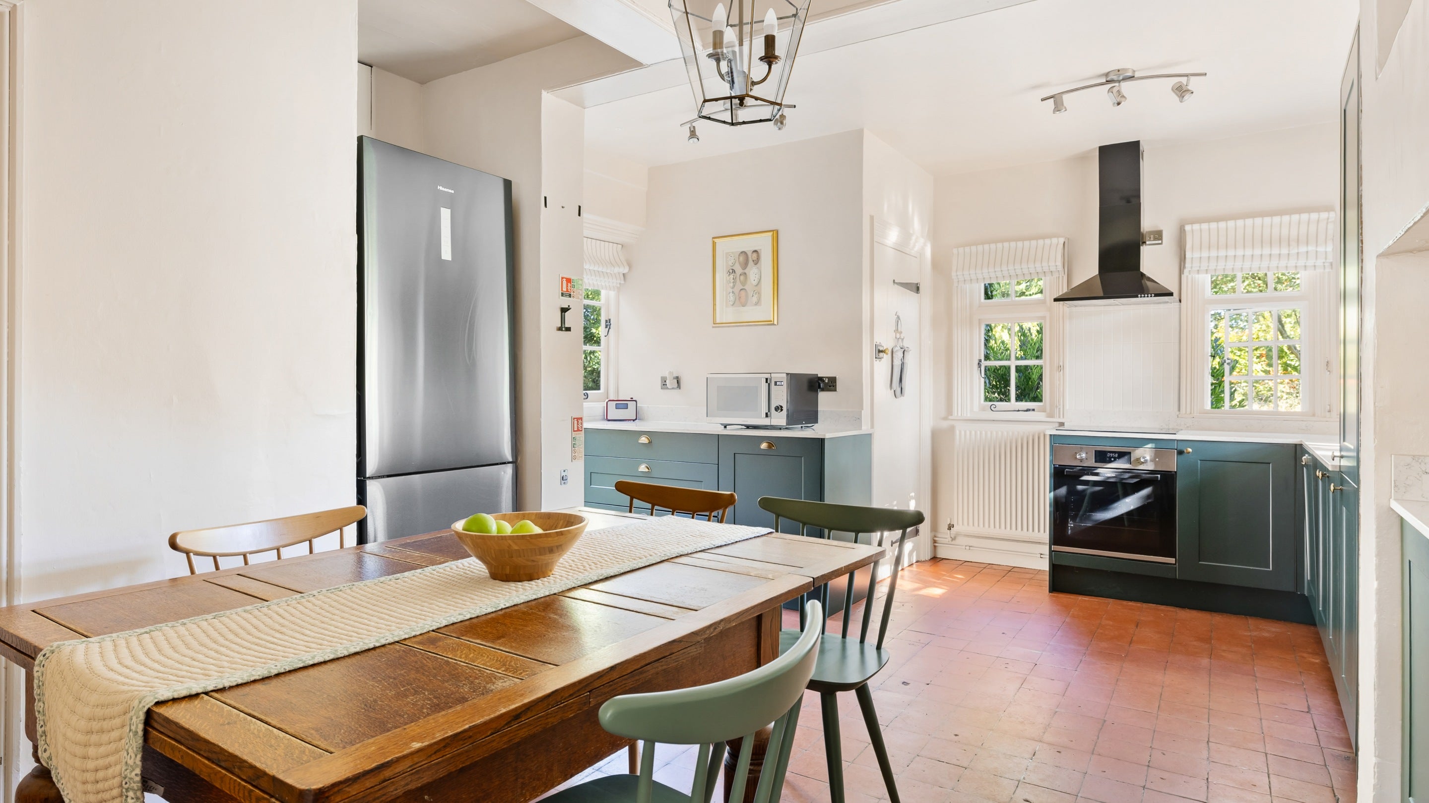 The kitchen with dining table at Polesden Garden Cottage, Surrey
