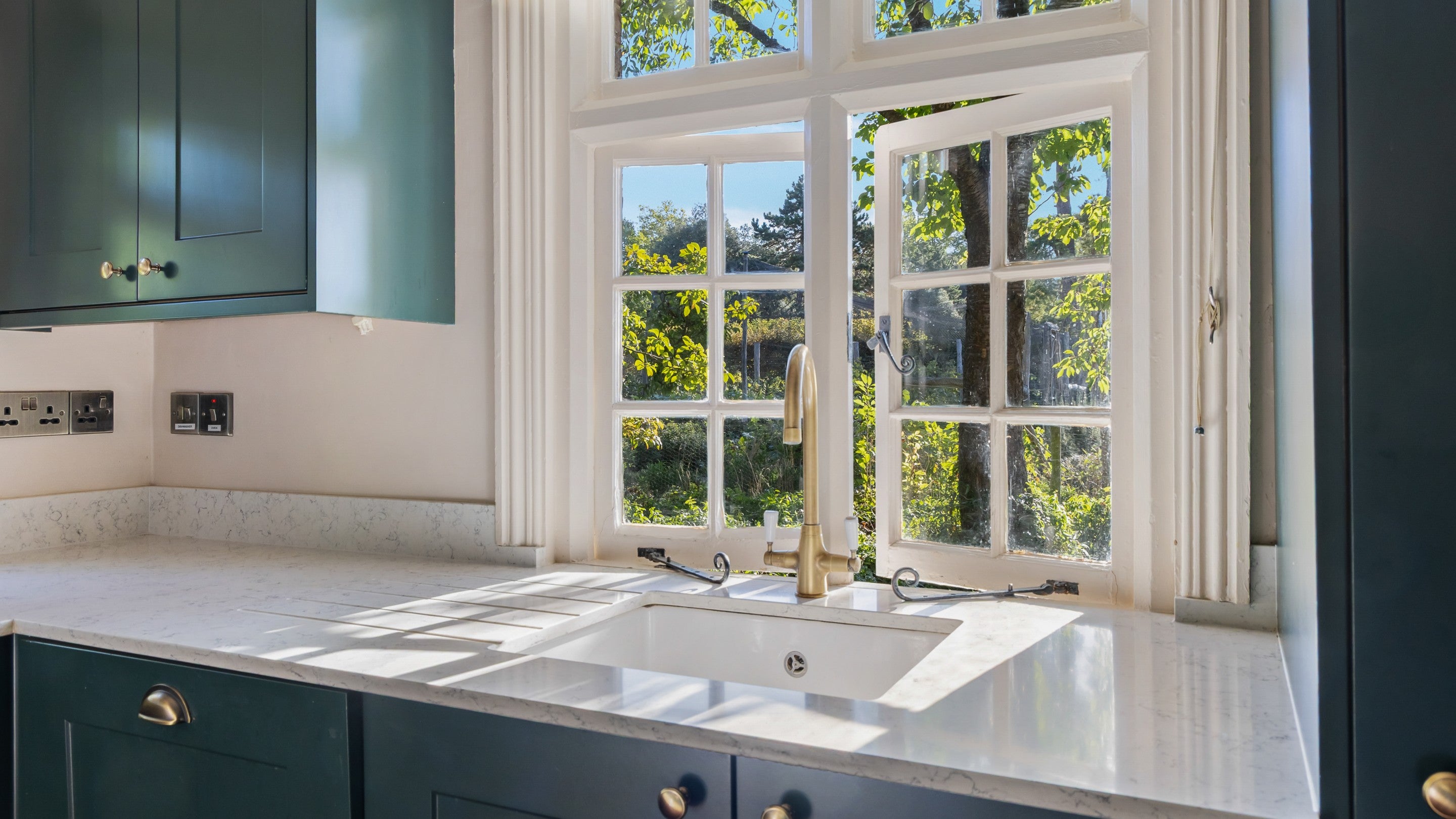 The sink in the kitchen at Polesden Garden Cottage, with window looking out over the garden, Surrey