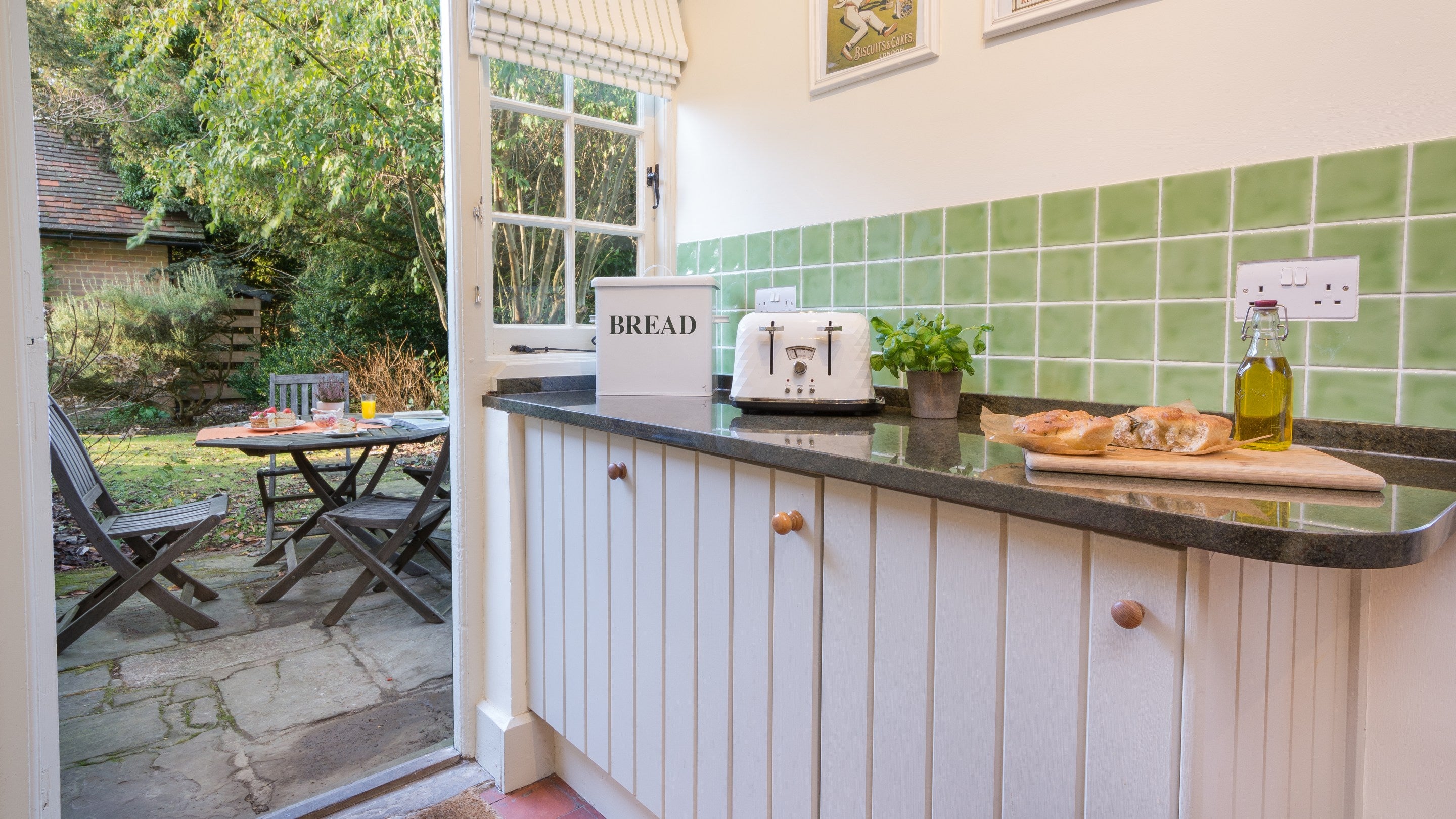 The kitchen exits onto the private garden patio at Polesden Garden Cottage, Surrey