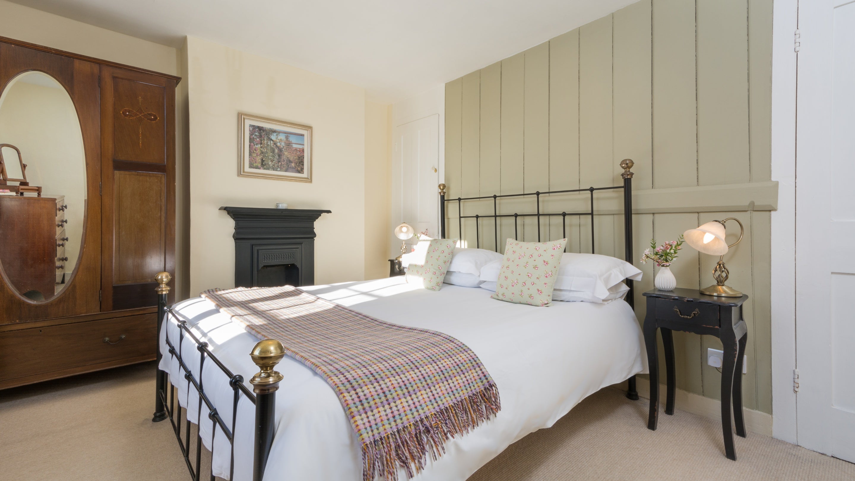The main bedroom with double bed on the first floor of Polesden Garden Cottage, Surrey