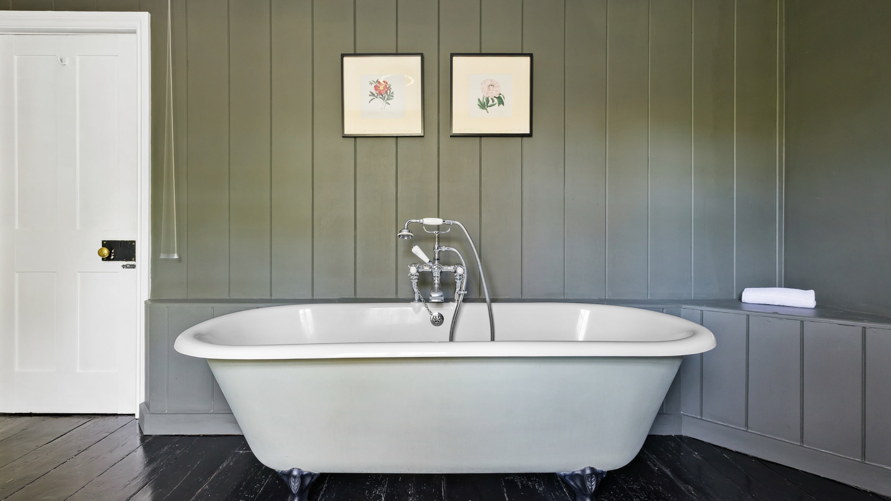The roll-top bath with shower attachment (no wall hook) on the first floor of Polesden Garden Cottage, Surrey