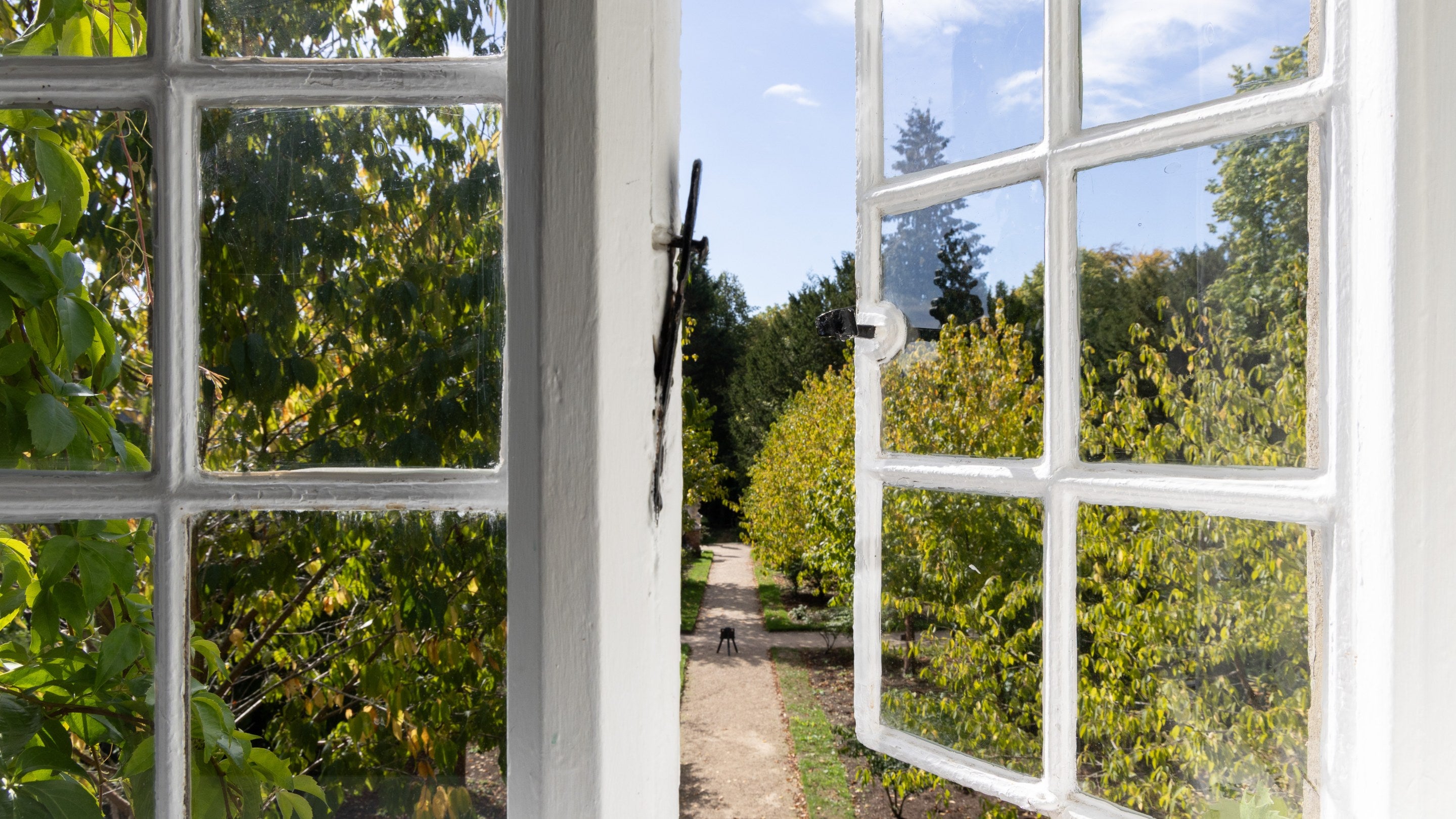 The view of part of the gardens at Polesden Lacey from the first-floor bedroom ay Polesden Garden Cottage, Surrey