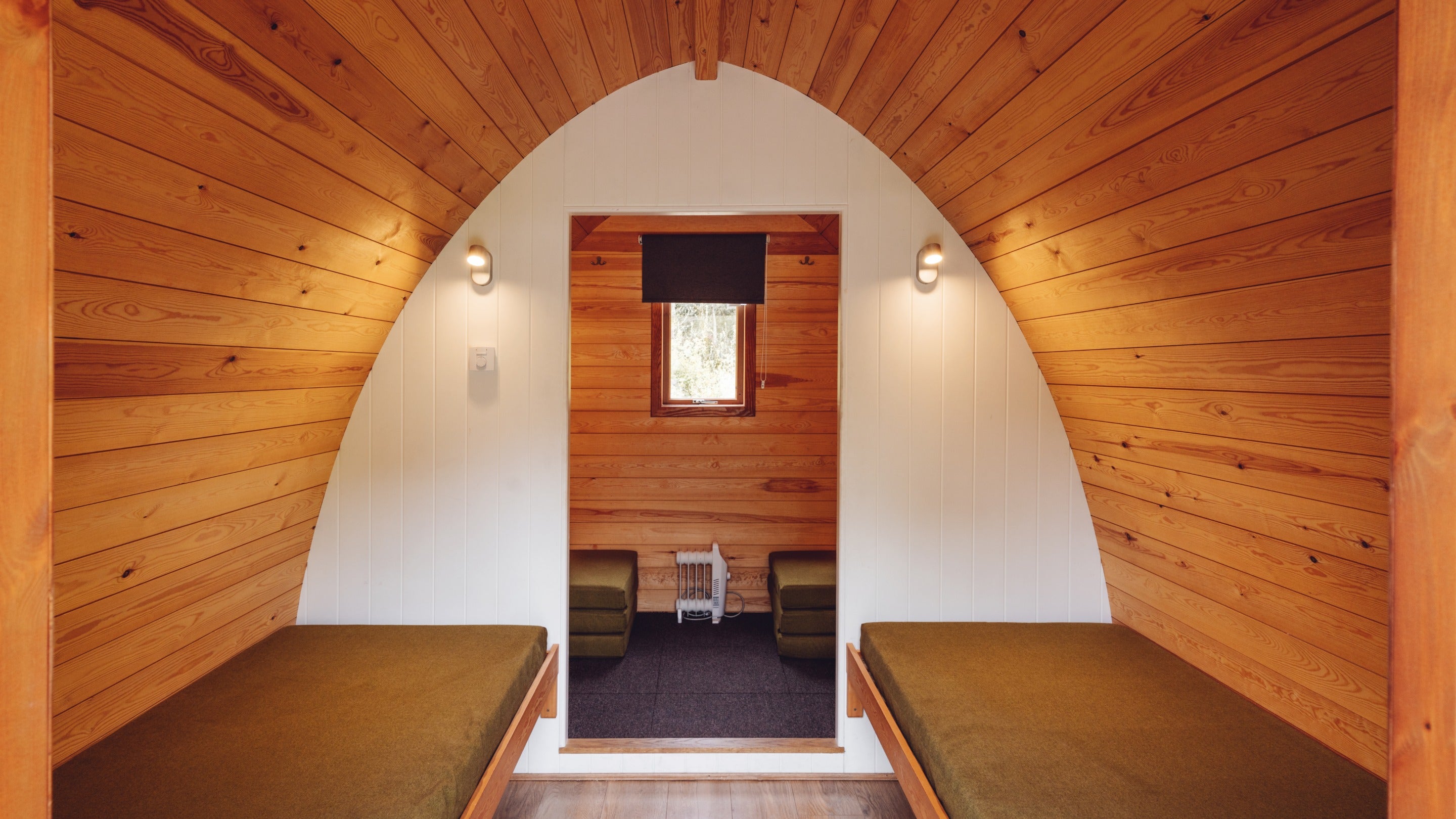 The interior of a Plus Pod, including bench seating, at Great Langdale Campsite, Cumbria
