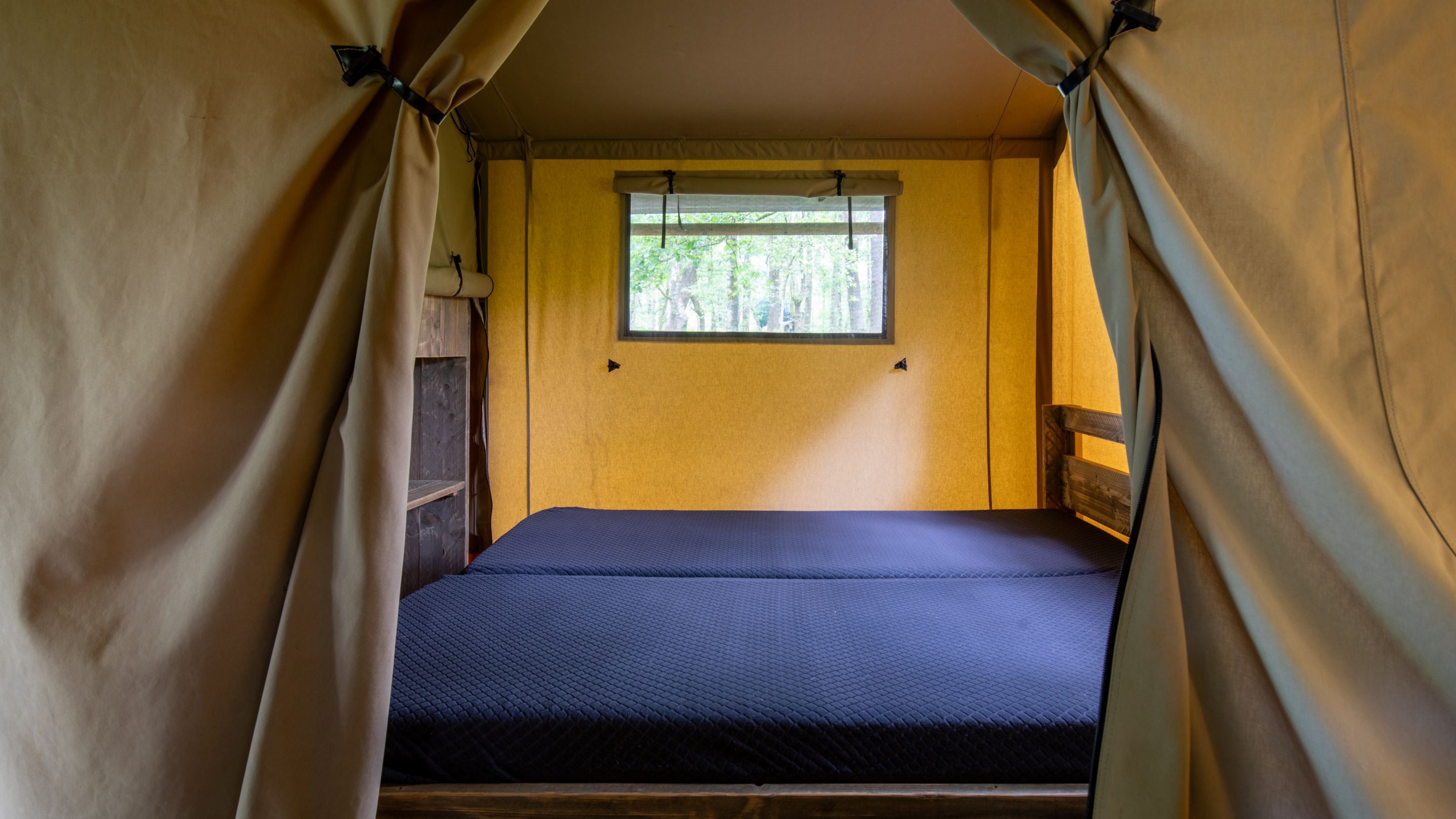 A double bed in a safari tent at Low Wray Campsite, Cumbria