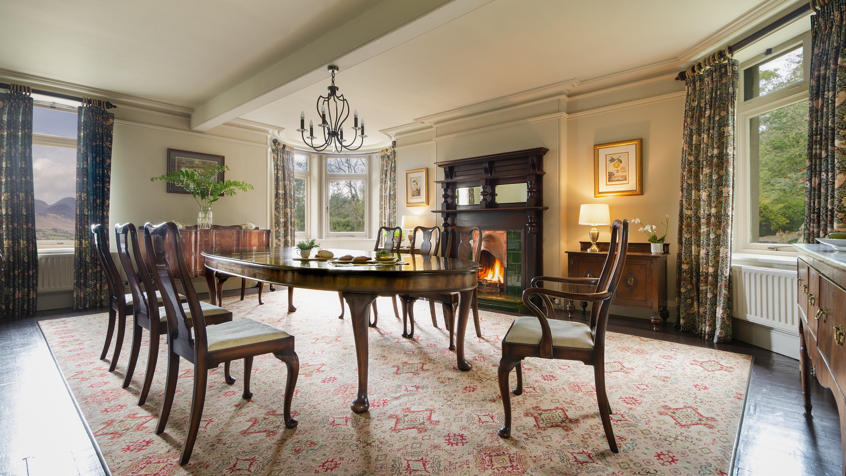 The dining room at Millbeck Towers, with original fireplace with copper work from the Keswick School of Industrial Arts, Cumbria
