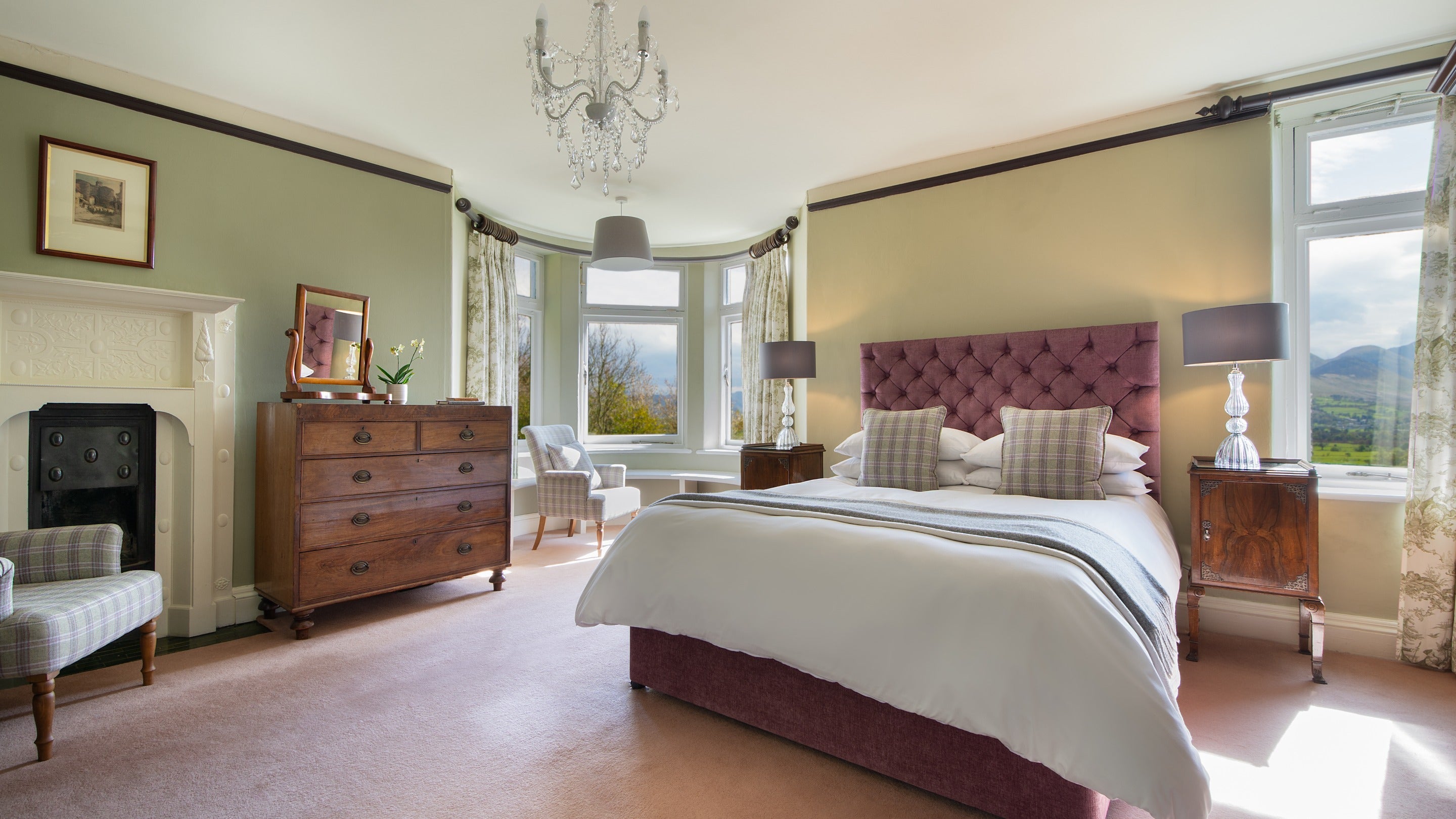 The second floor double bedroom with en-suite bathroom at Millbeck Towers, with views towards the Derwent Fells, Cumbria