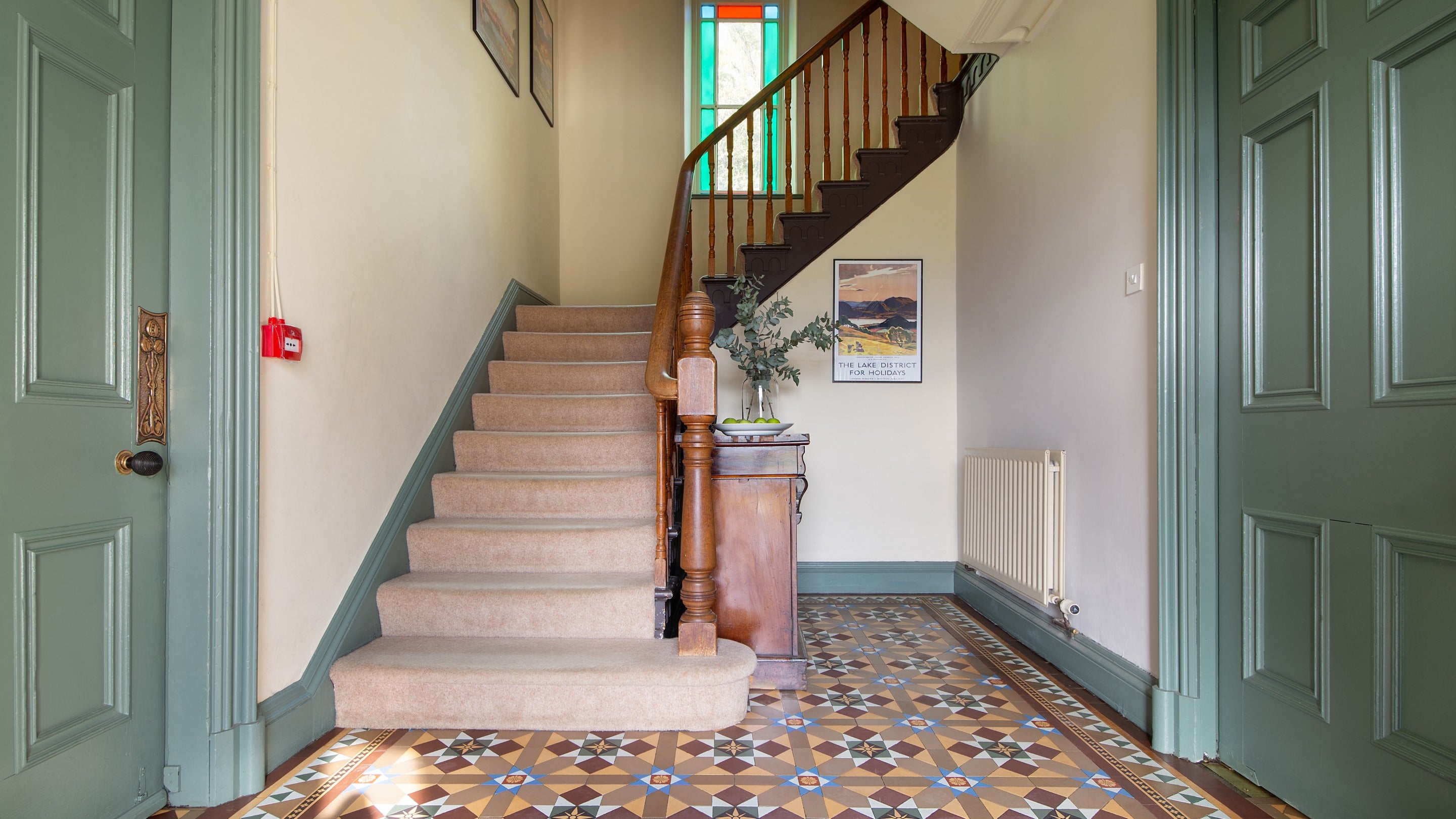 The entrance hall with tiled floor at Millbeck Towers, with dining room to the left and kitchen to the right, Cumbria