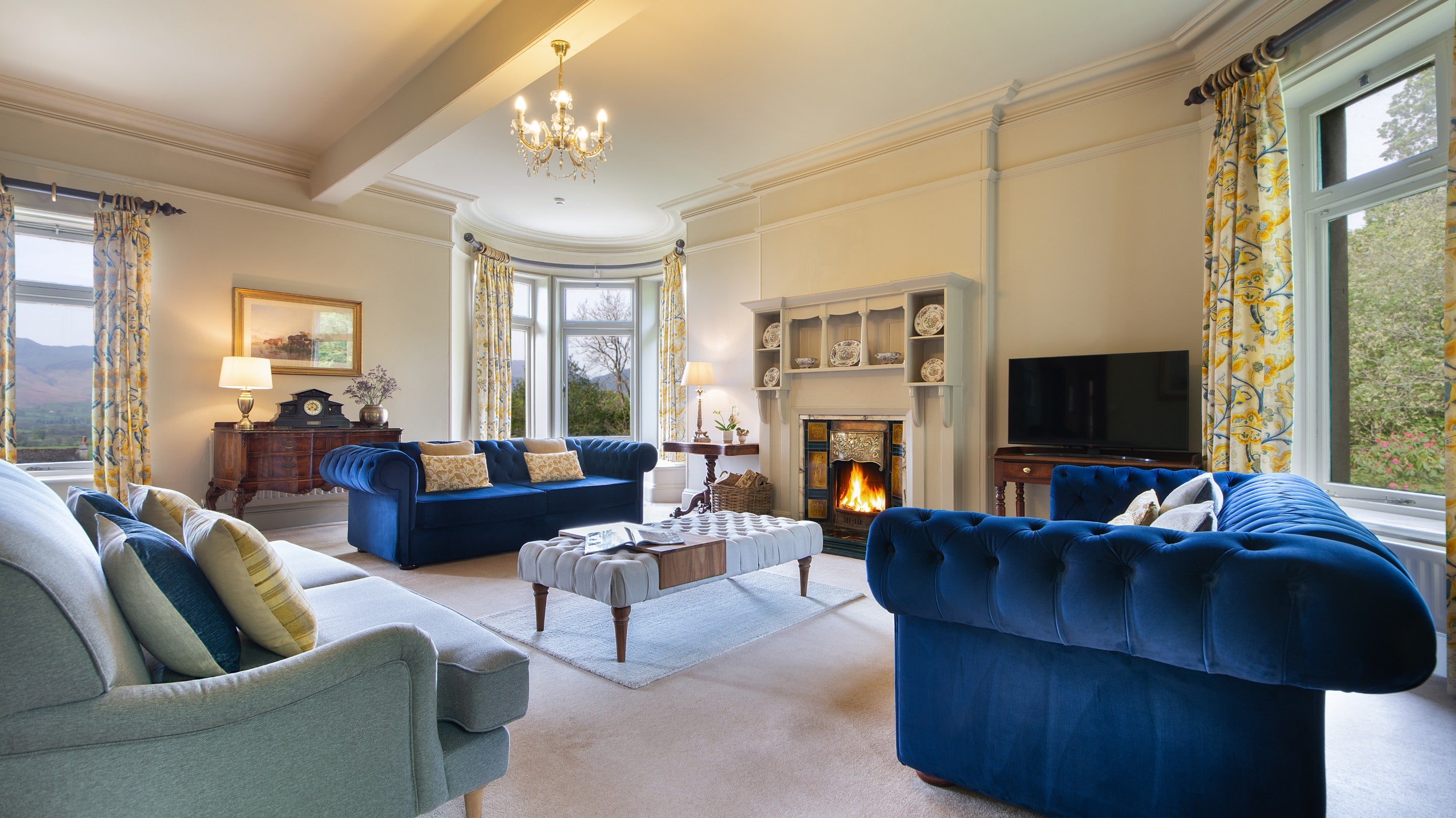 The sitting room at Millbeck Towers, with front windows looking towards the Derwent Fells, Cumbria