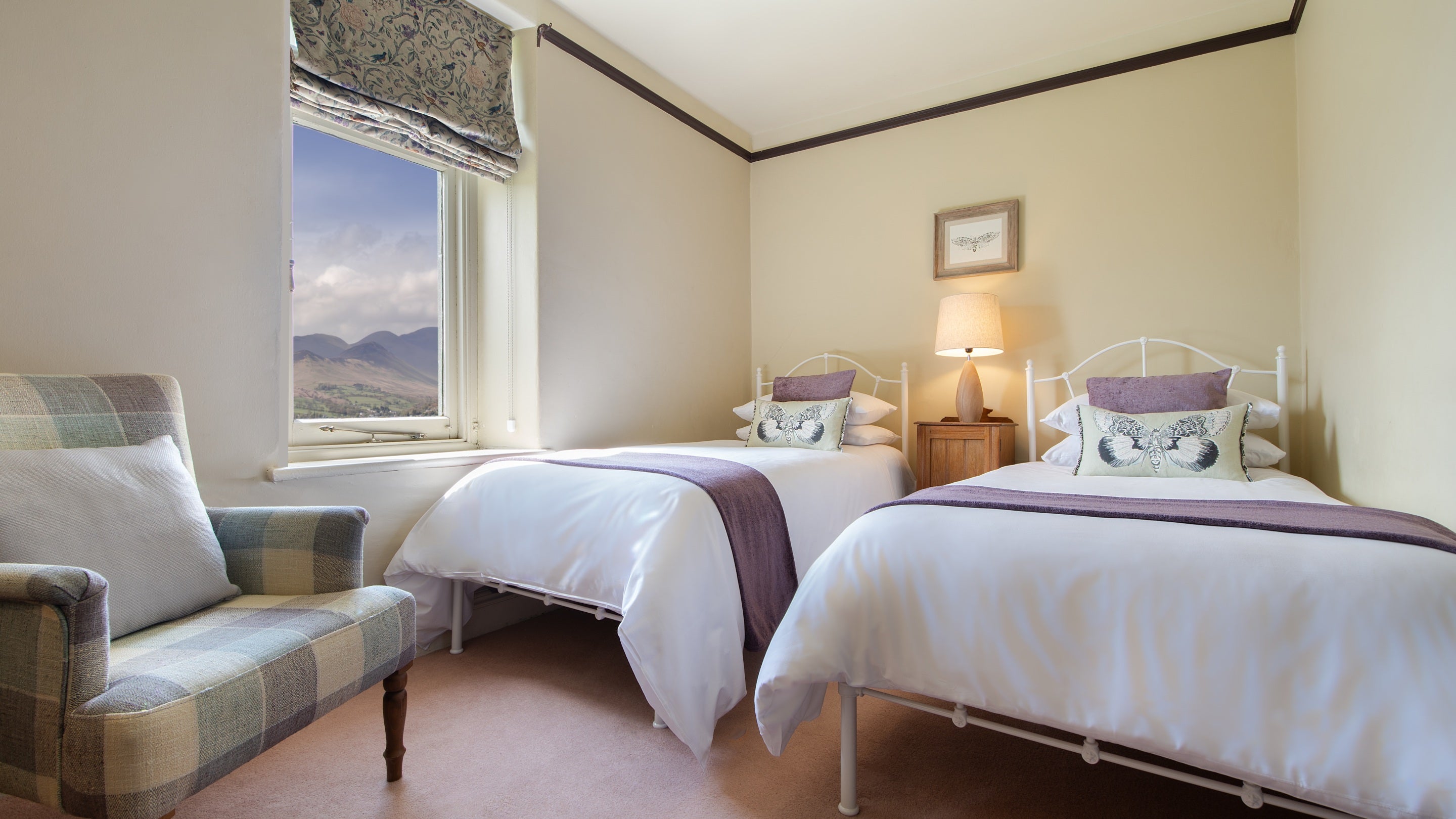 The second floor twin bedroom with views towards the Derwent Fells at Millbeck Towers, Cumbria