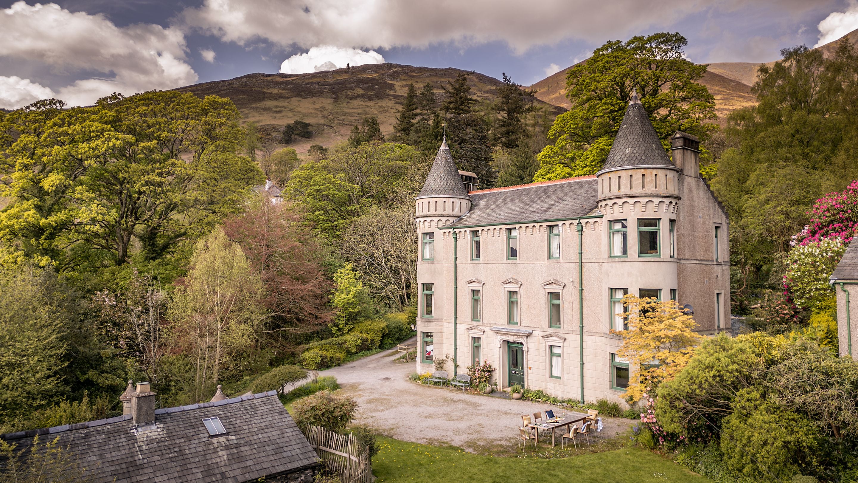 An aerial view of the front of Millbeck Towers, with Skiddaw in the background, Cumbria