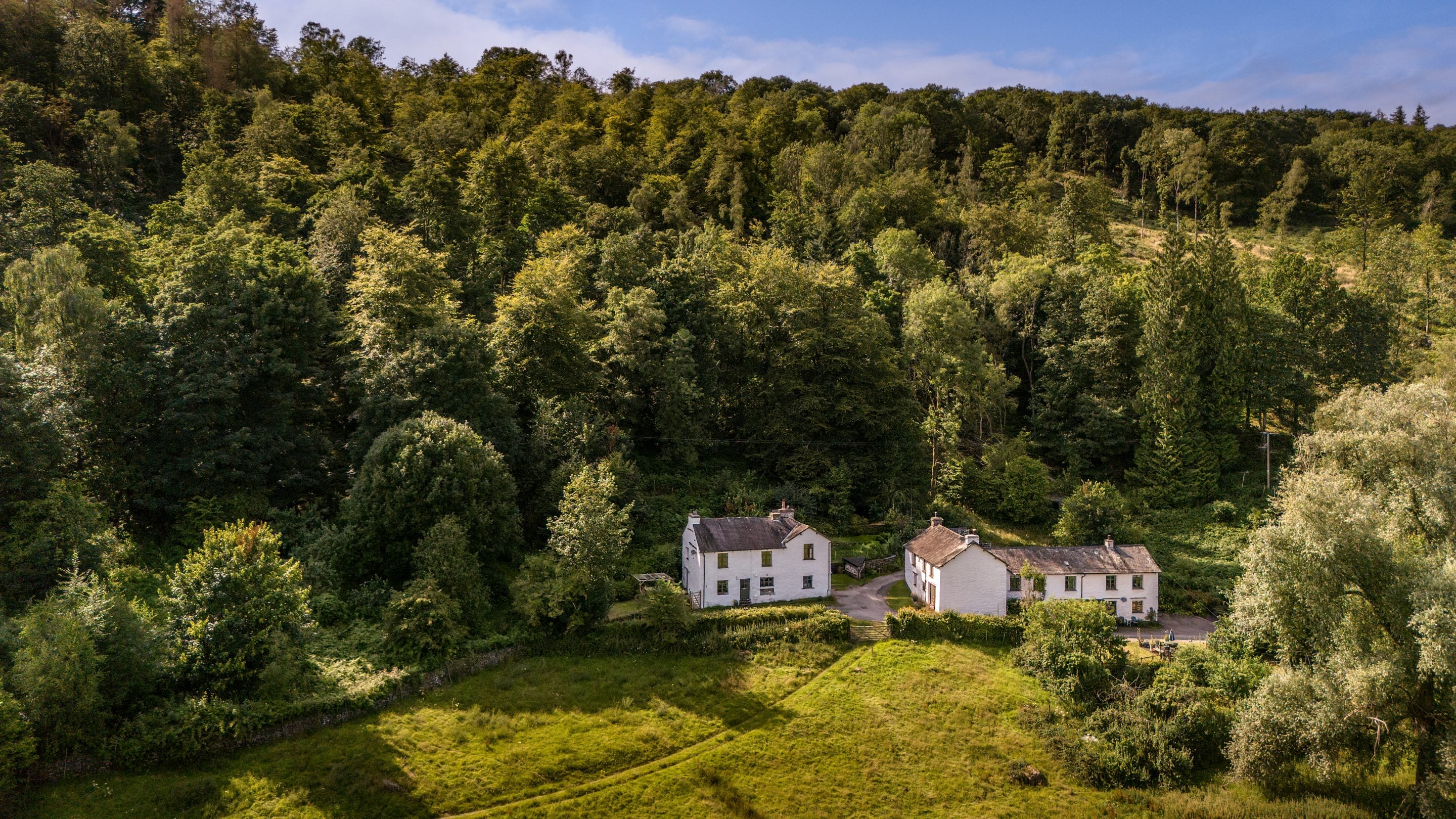 An aerial view of Restharrow (middle of building on the right), Tanner Brow (to the left of Restharrow) and neighbouring buildings (to the left of the picture and the right of Restharrow), Cumbria