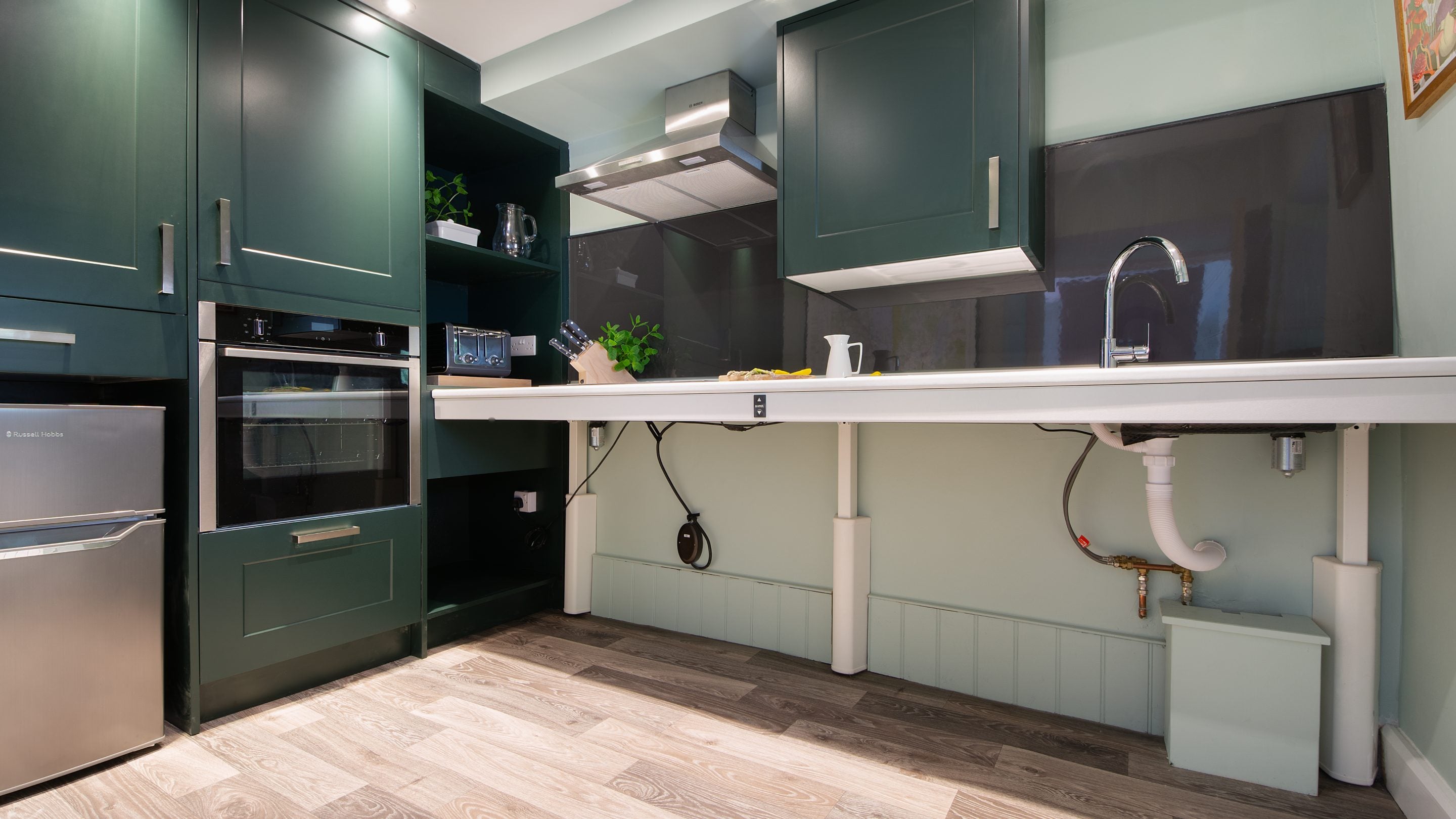 The kitchen, with height-adjustable hob and sink and slide-and-hide oven, at Restharrow, Cumbria