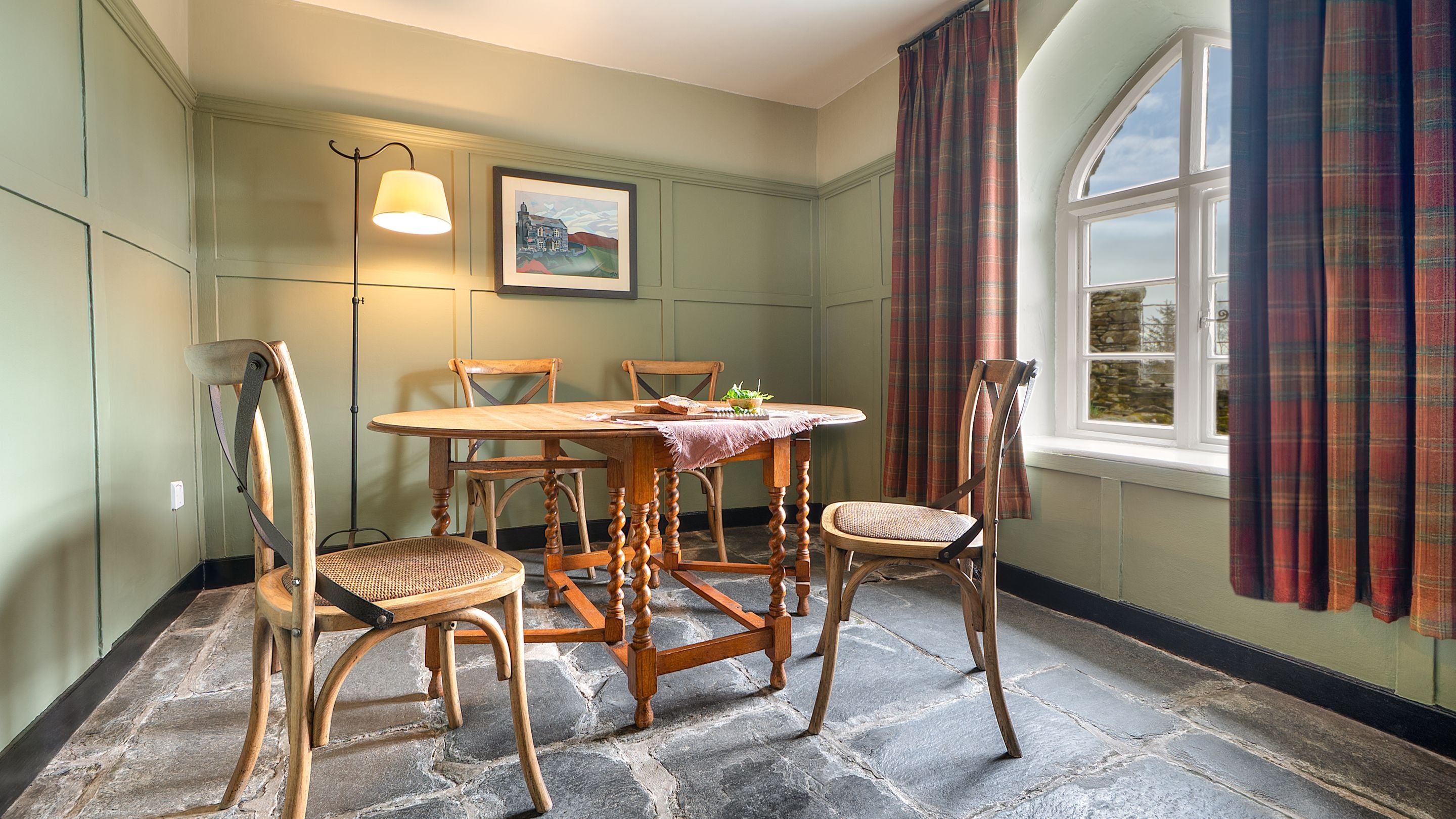 The dining table in the open-plan sitting and dining room at Rose Castle Cottage, Cumbria