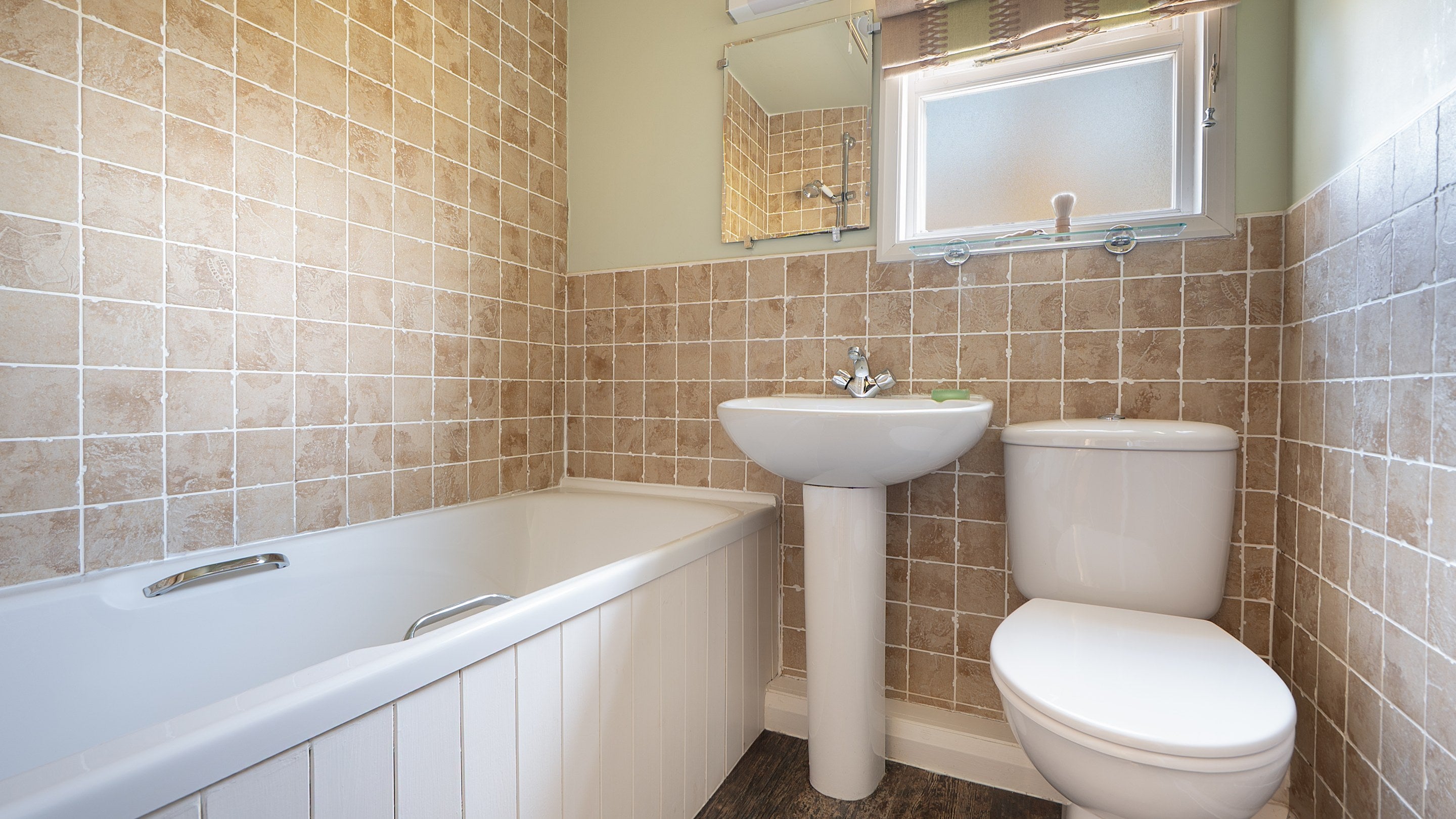 The bathroom at The Summer House, with shower over bath, Cumbria