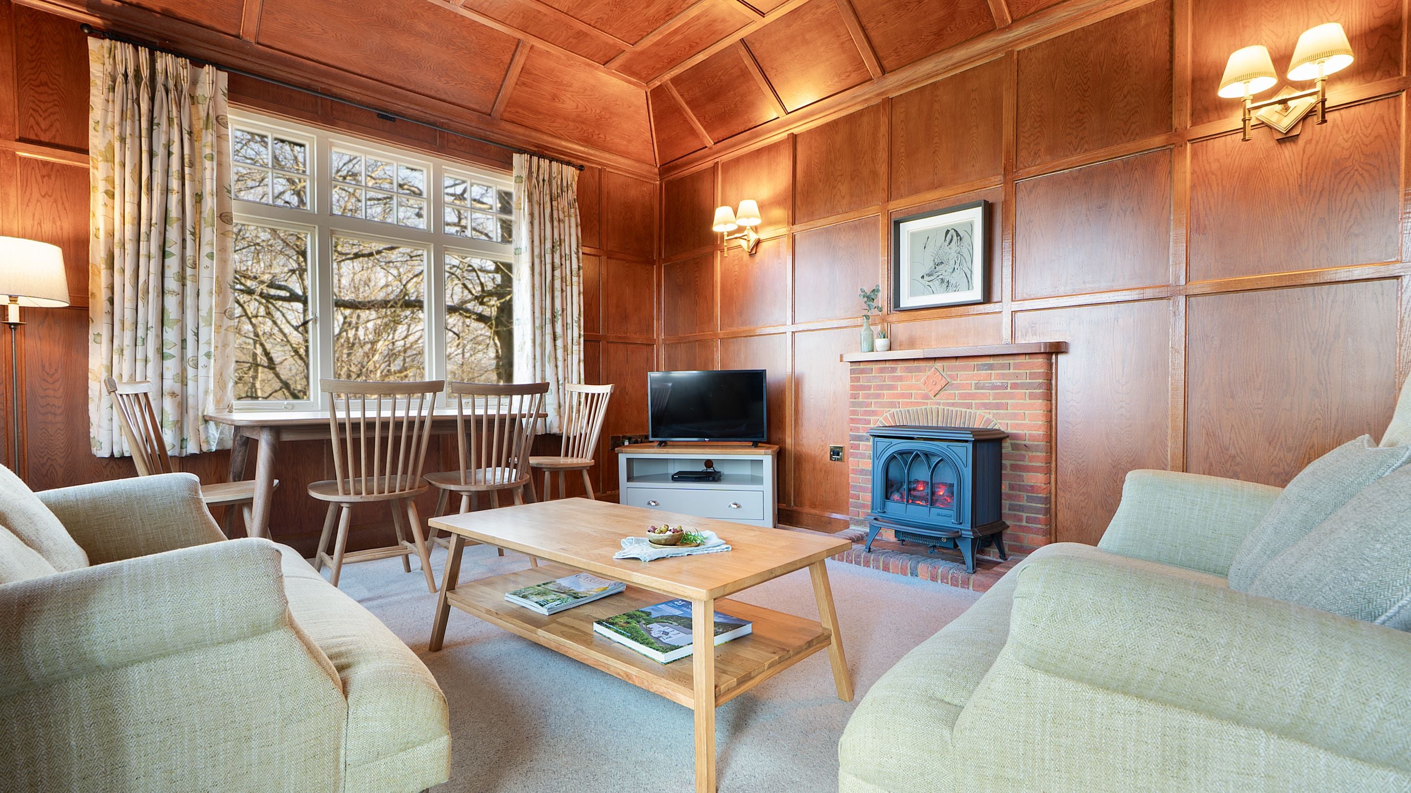 The sitting room at The Summer House, which has wood-panelled walls and ceiling, Cumbria