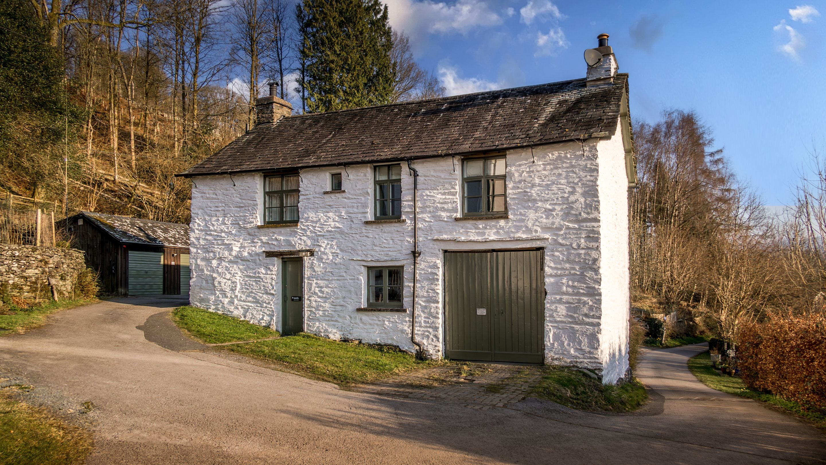 The exterior of Tanner Brow, a first-floor apartment, with the door to its shared laundry room on the ground floor beneath, Cumbria