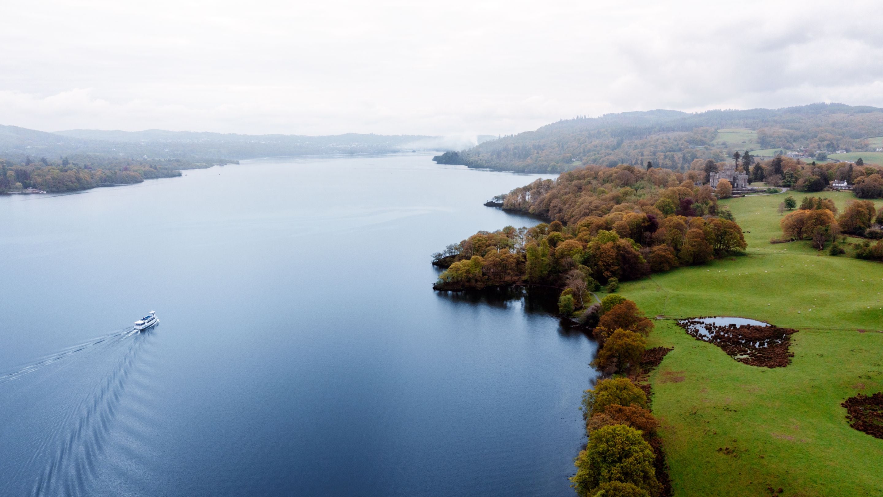 An aerial view of Windermere showing Wray Castle and Wray Castle House in the top right, Cumbria